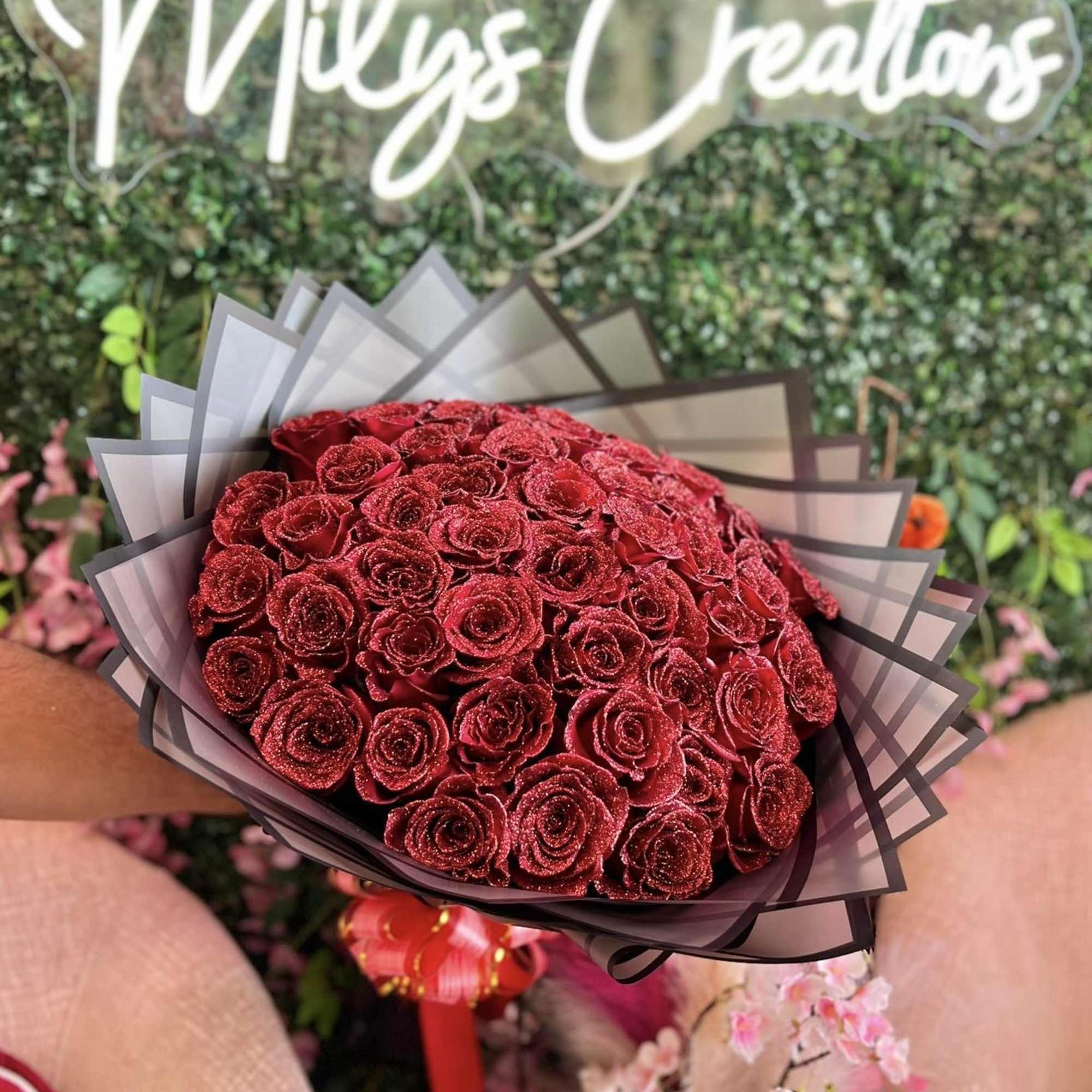 Bouquet of red roses wrapped in dark paper