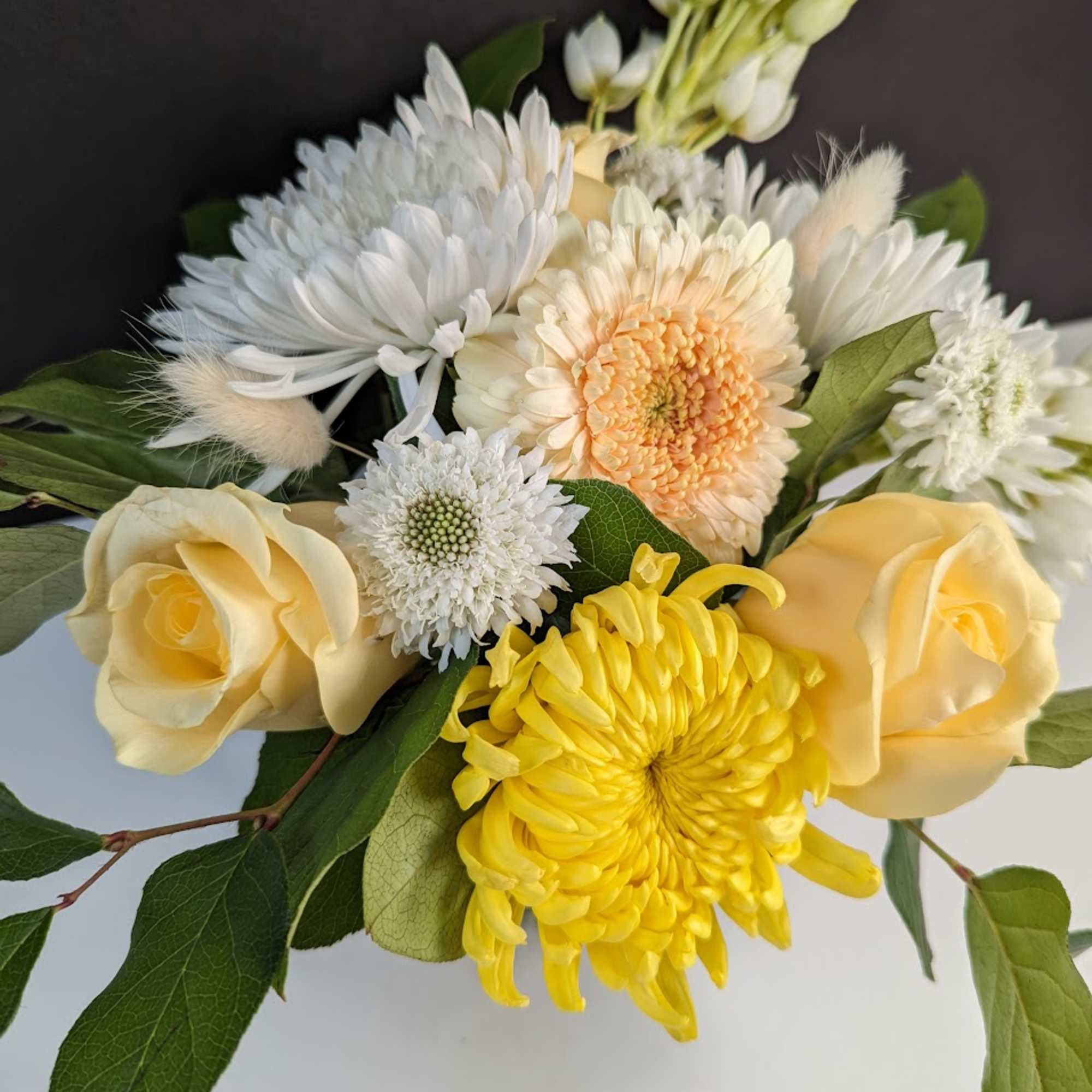 Bouquet of yellow and white flowers with roses and chrysanthemums