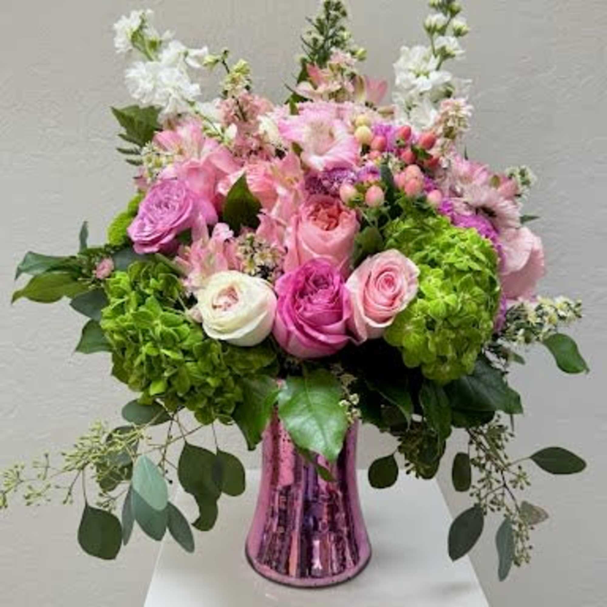 Pink and white rose bouquet in a metallic pink vase