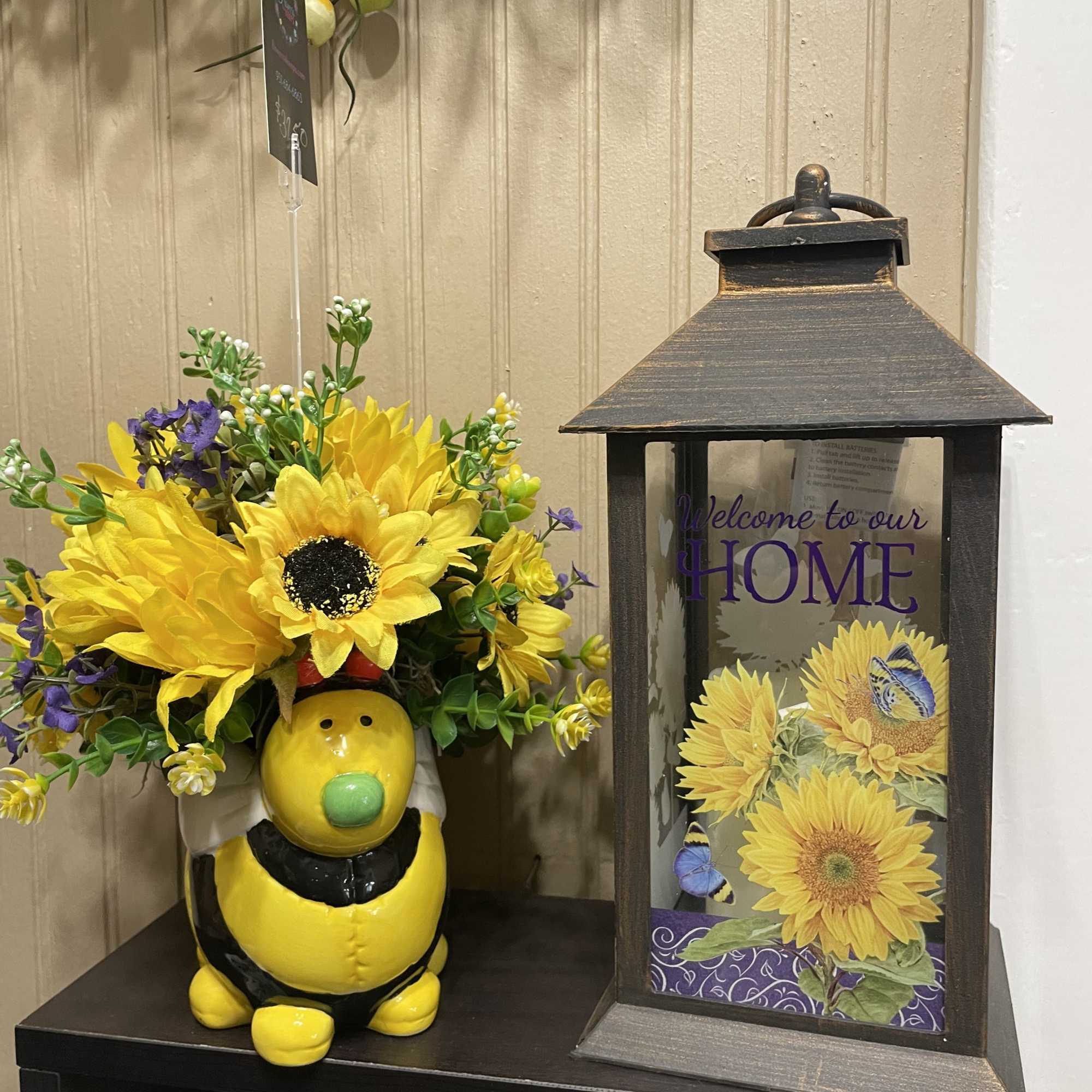 The cutest ceramic bee surrounded by silk flowers in lovely shades.. All