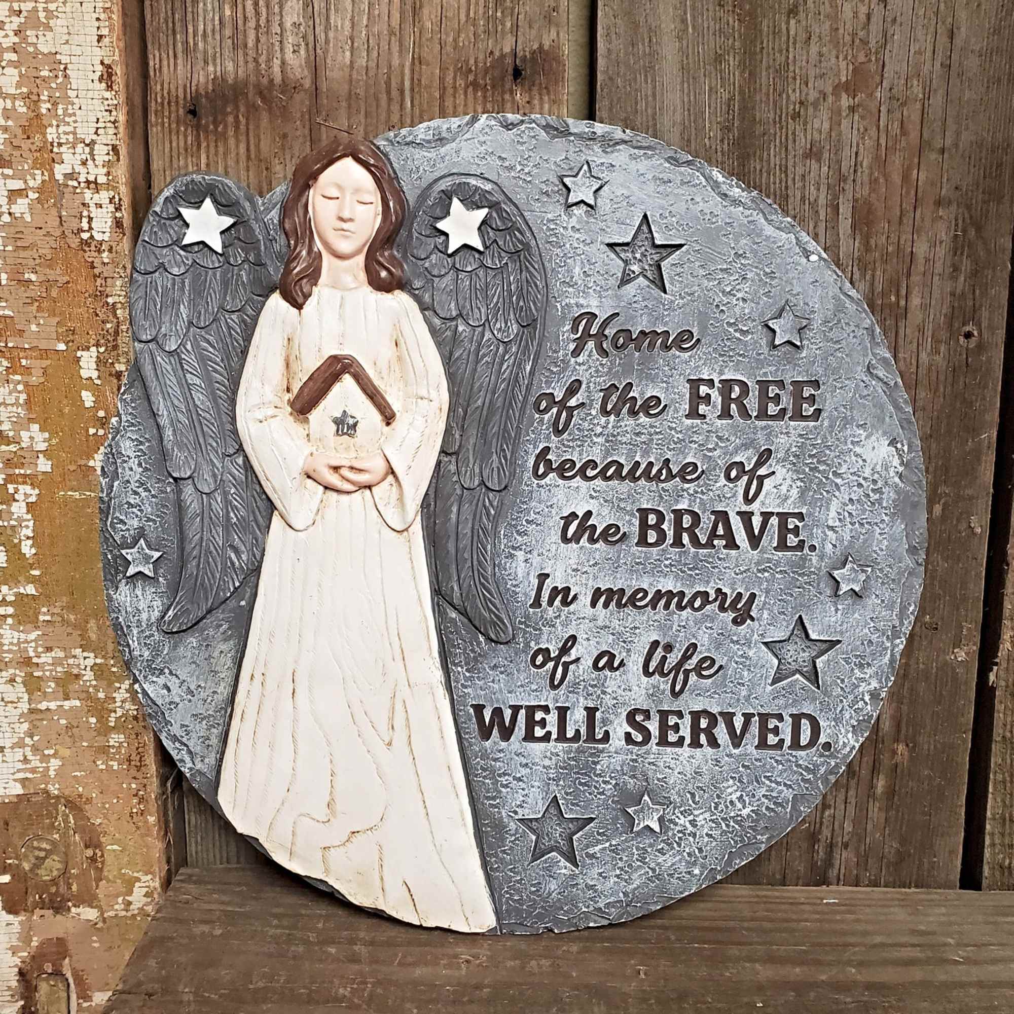 Round memorial plaque with an angel and patriotic text