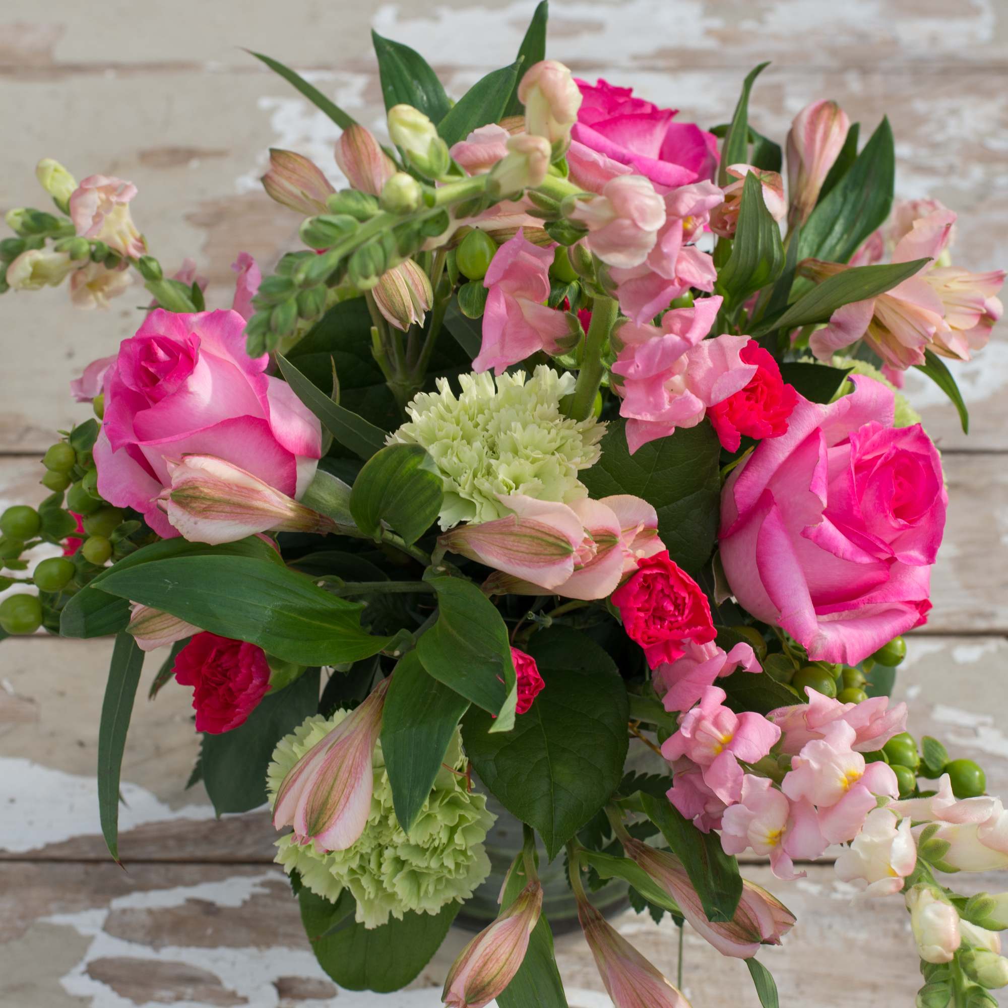 Pink roses and mixed pastel flowers in a hand-tied bouquet