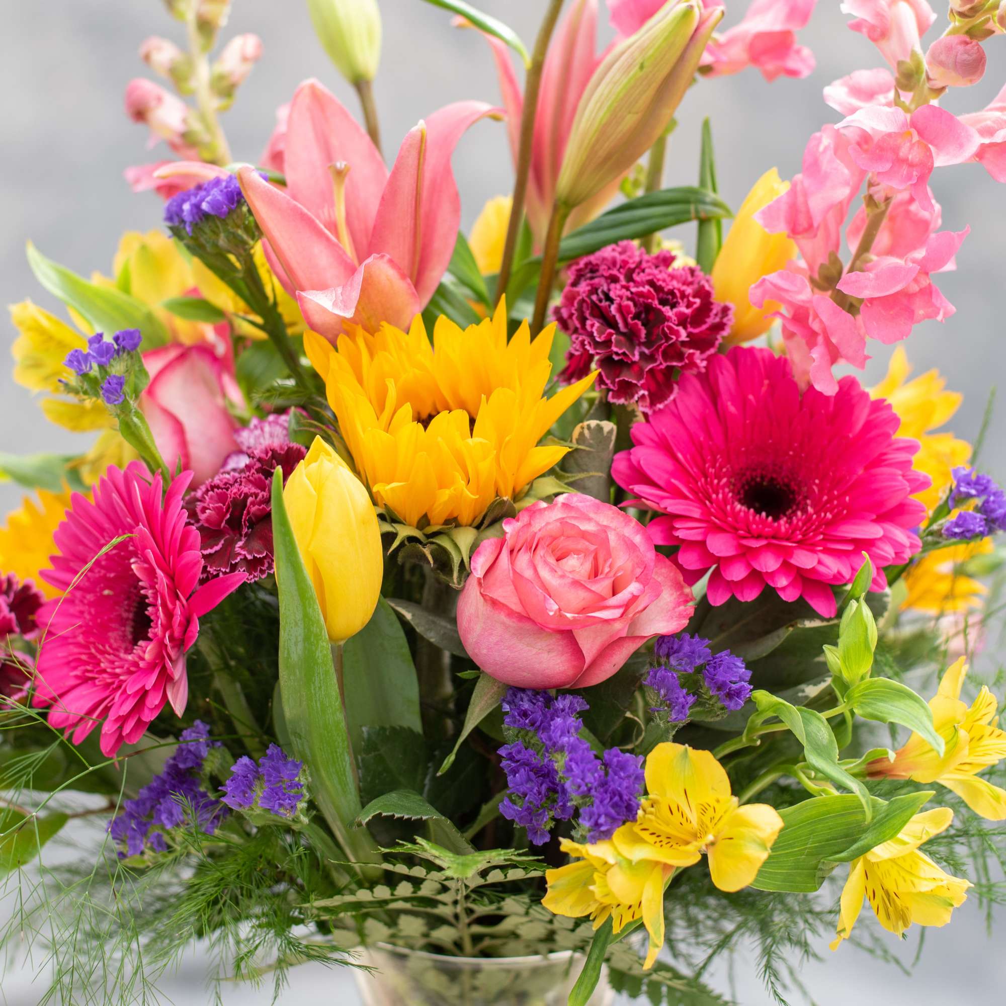 Colorful mixed bouquet with roses, lilies, gerbera daisies, and tulips