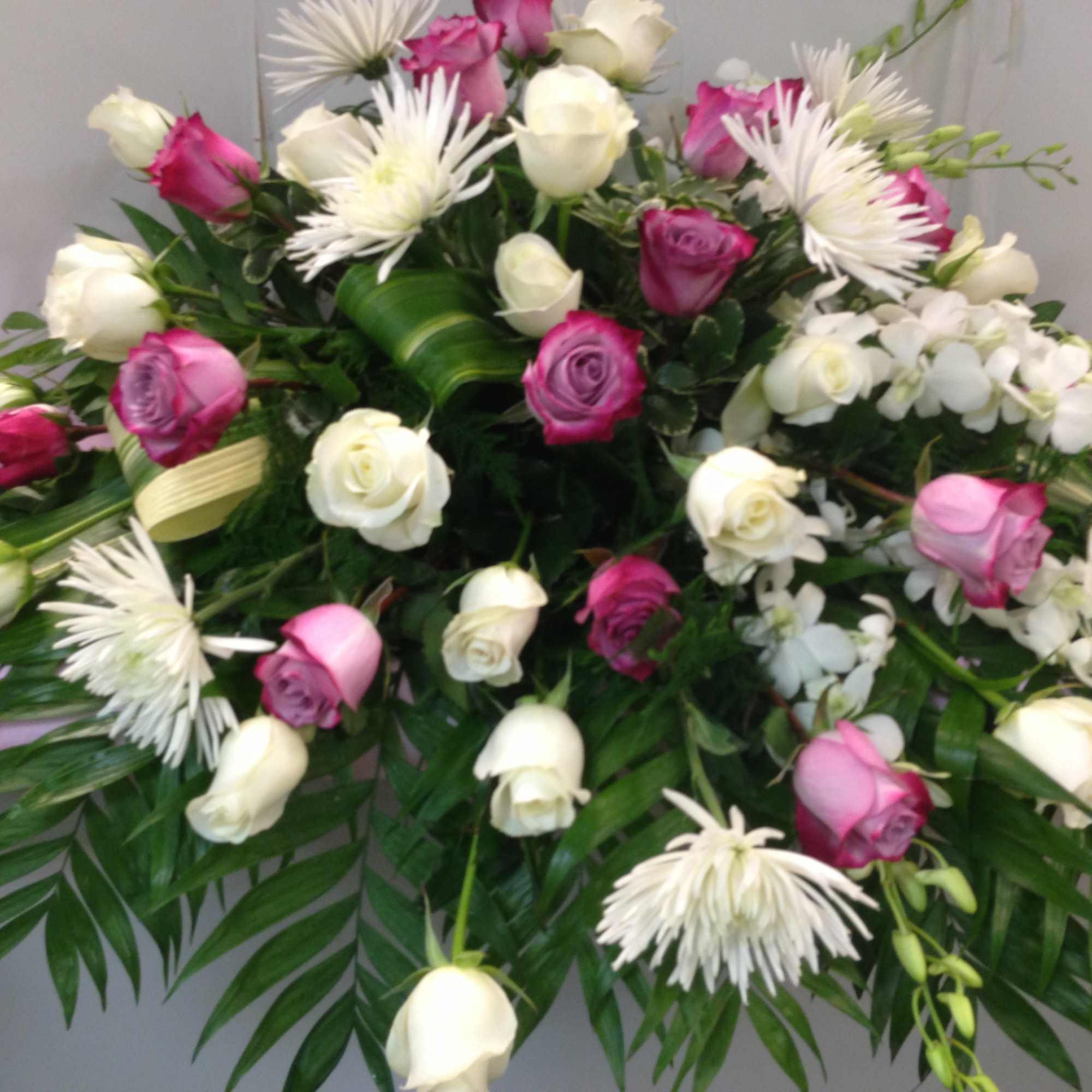 Large bouquet of pink and white roses with white spider mums