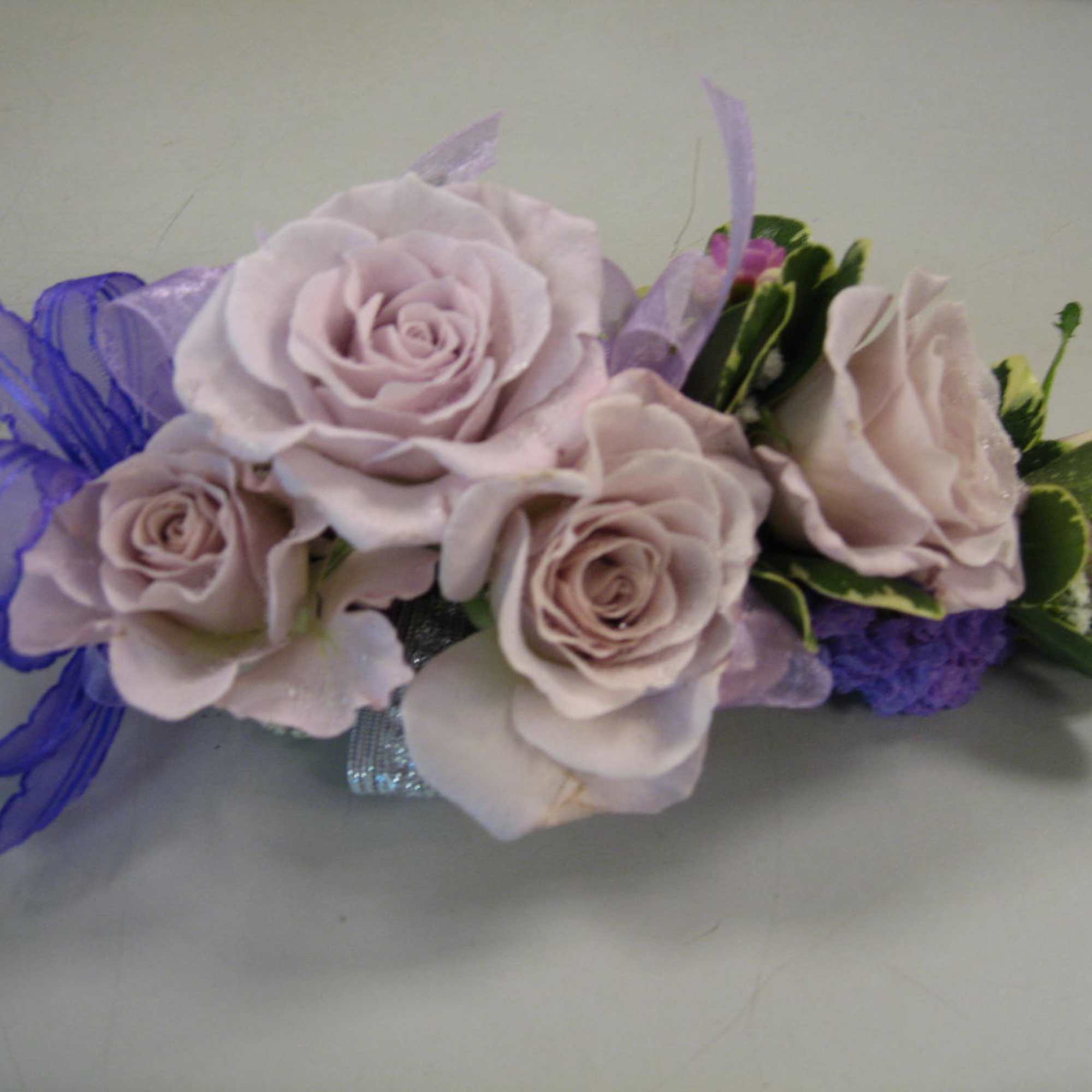 Lavender rose corsage with purple ribbon