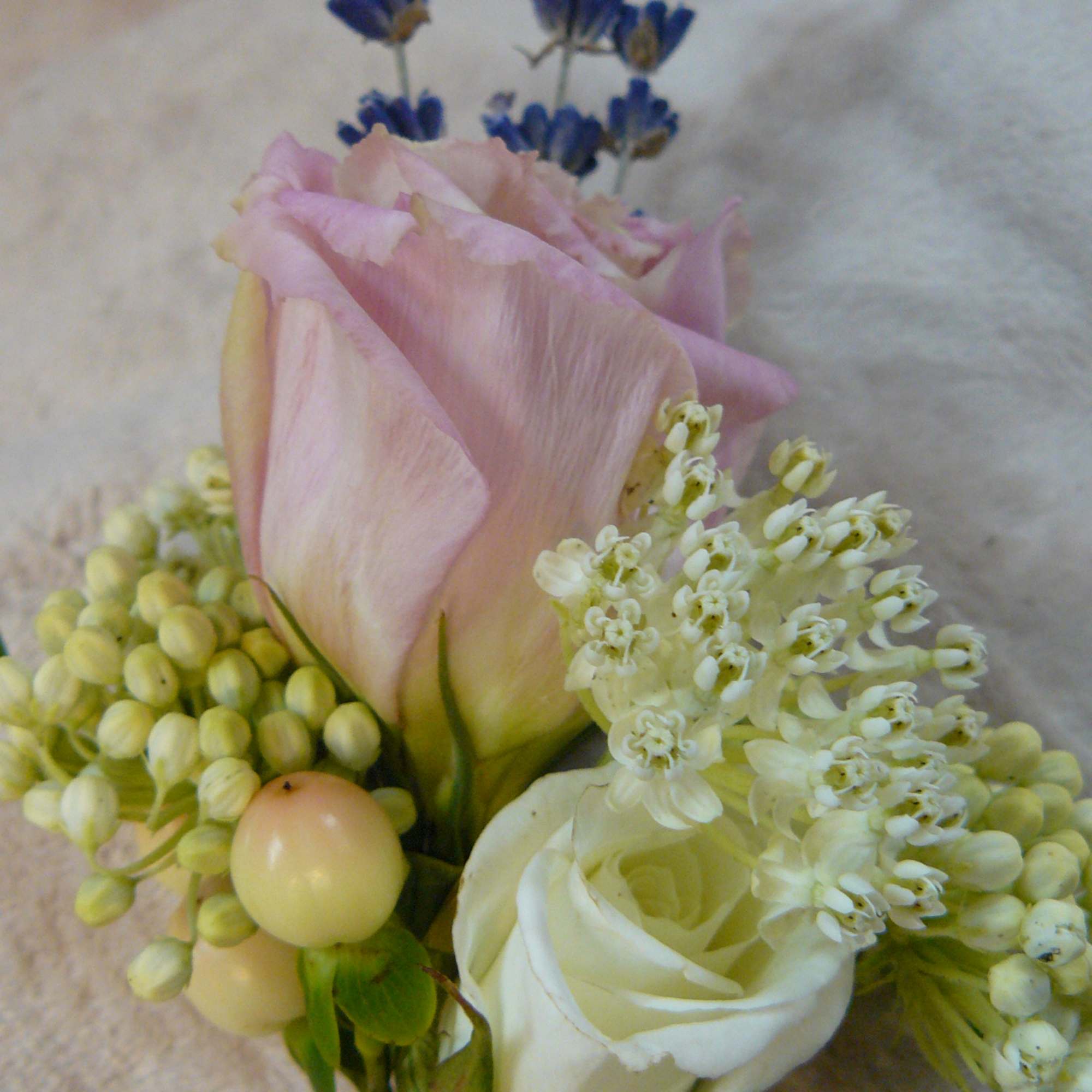 Small bouquet with pink and white roses and blue flowers
