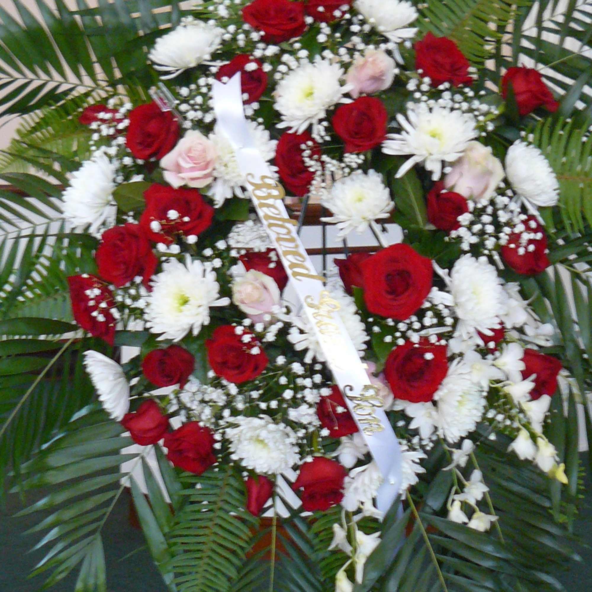 Standing floral spray with red and white roses and white daisies