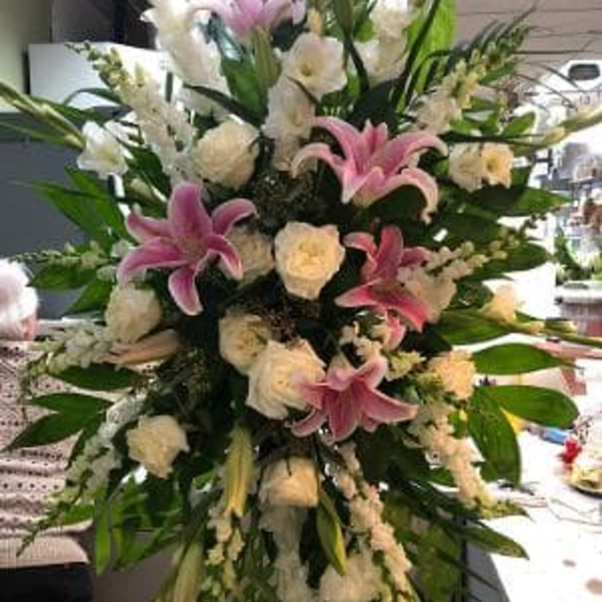 Tall floral spray with pink lilies and white flowers