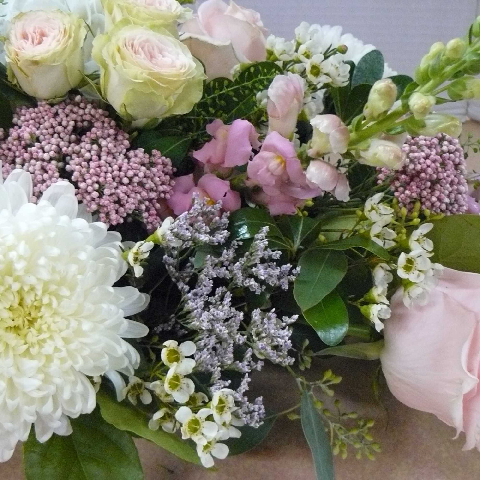 Bouquet of pale pink and white flowers with mixed greenery