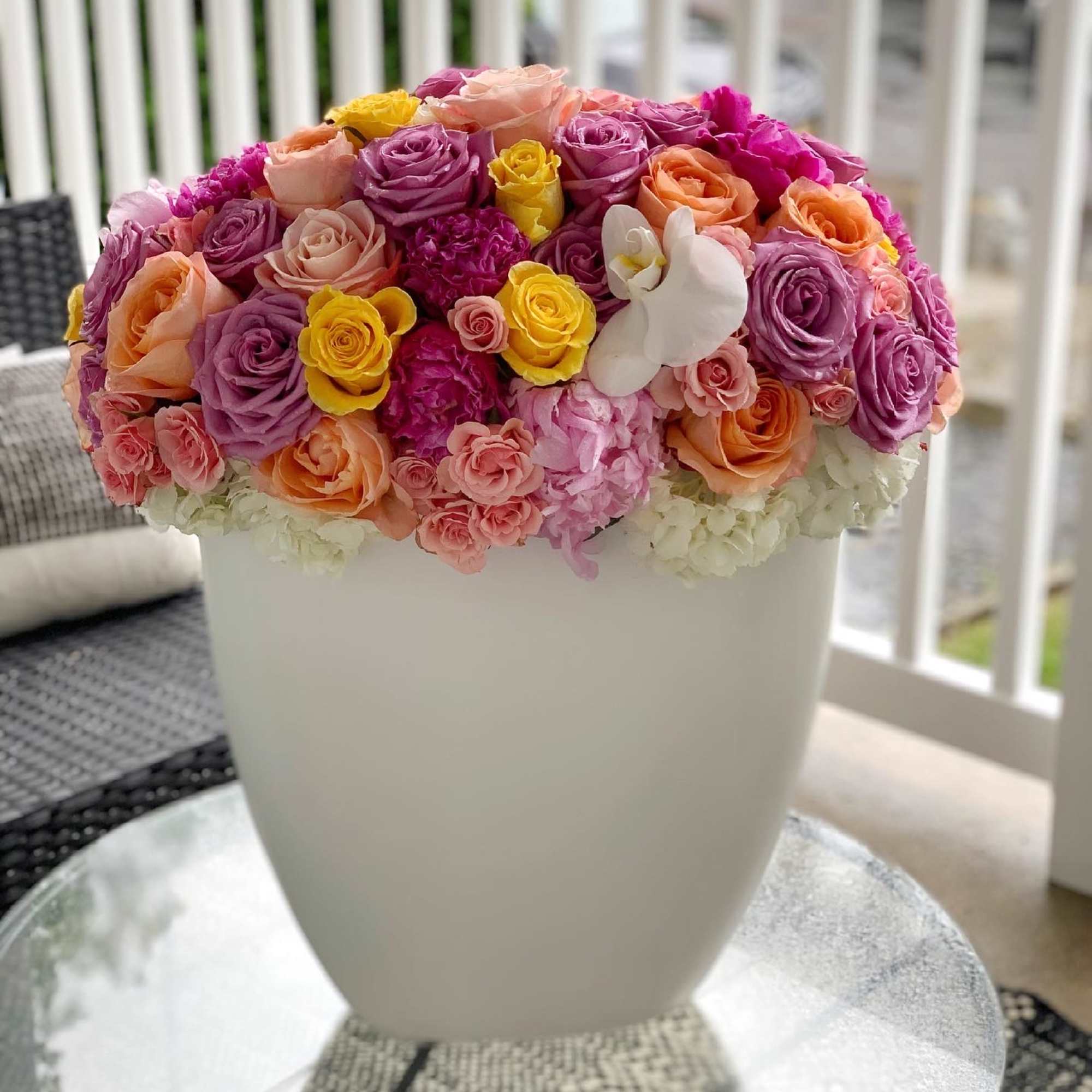 Colorful rose arrangement in a white vase, photo 3 of 5