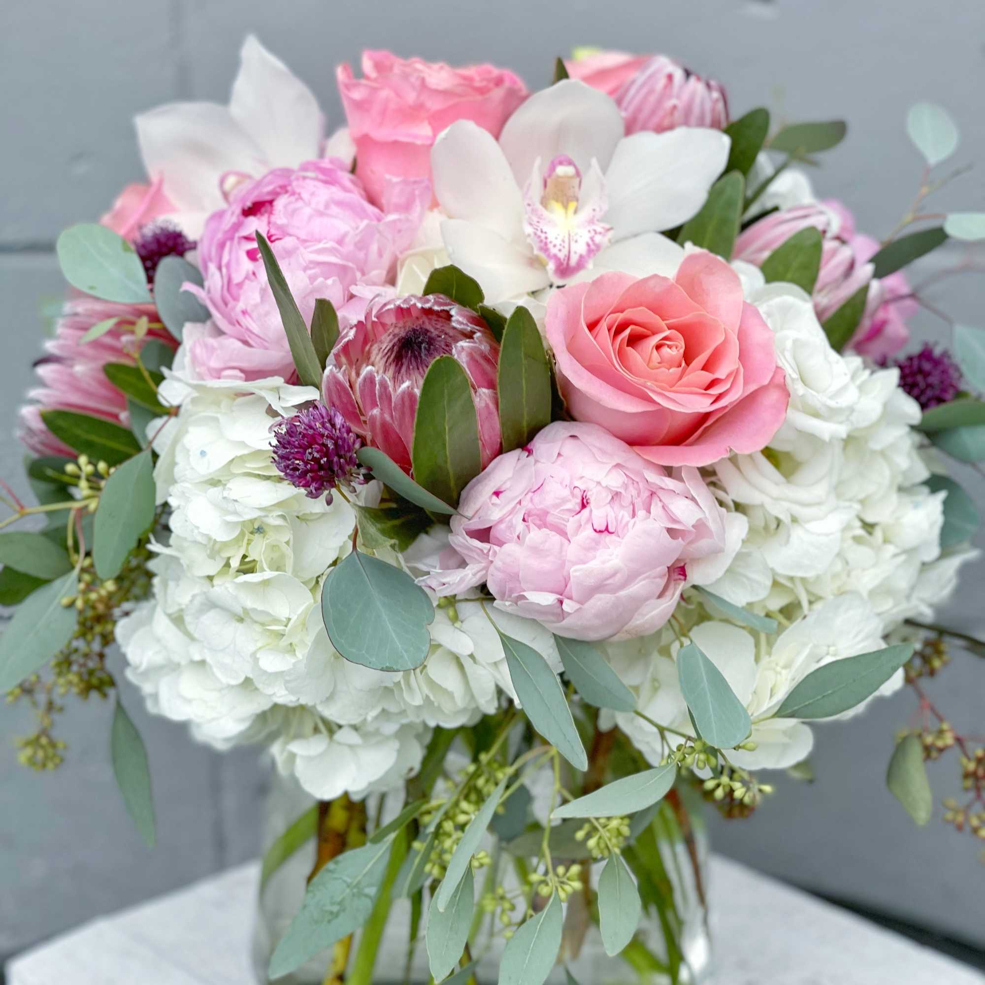 Pink and white mixed bouquet in a clear glass vase