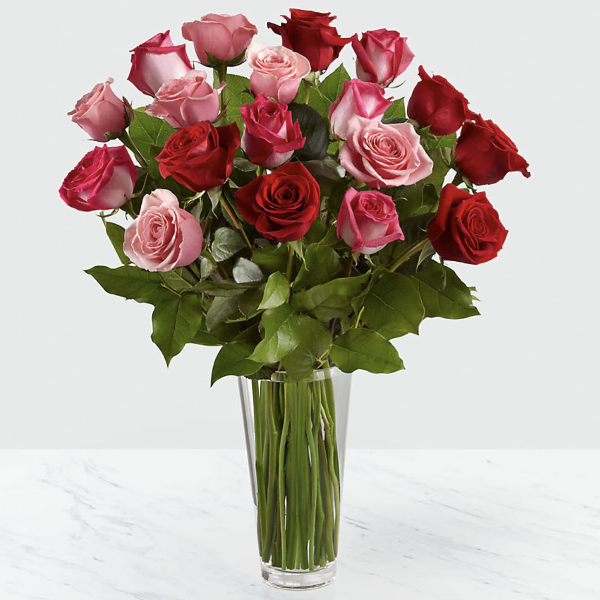 Bouquet of red and pink roses in a clear glass vase, photo 2 of 3