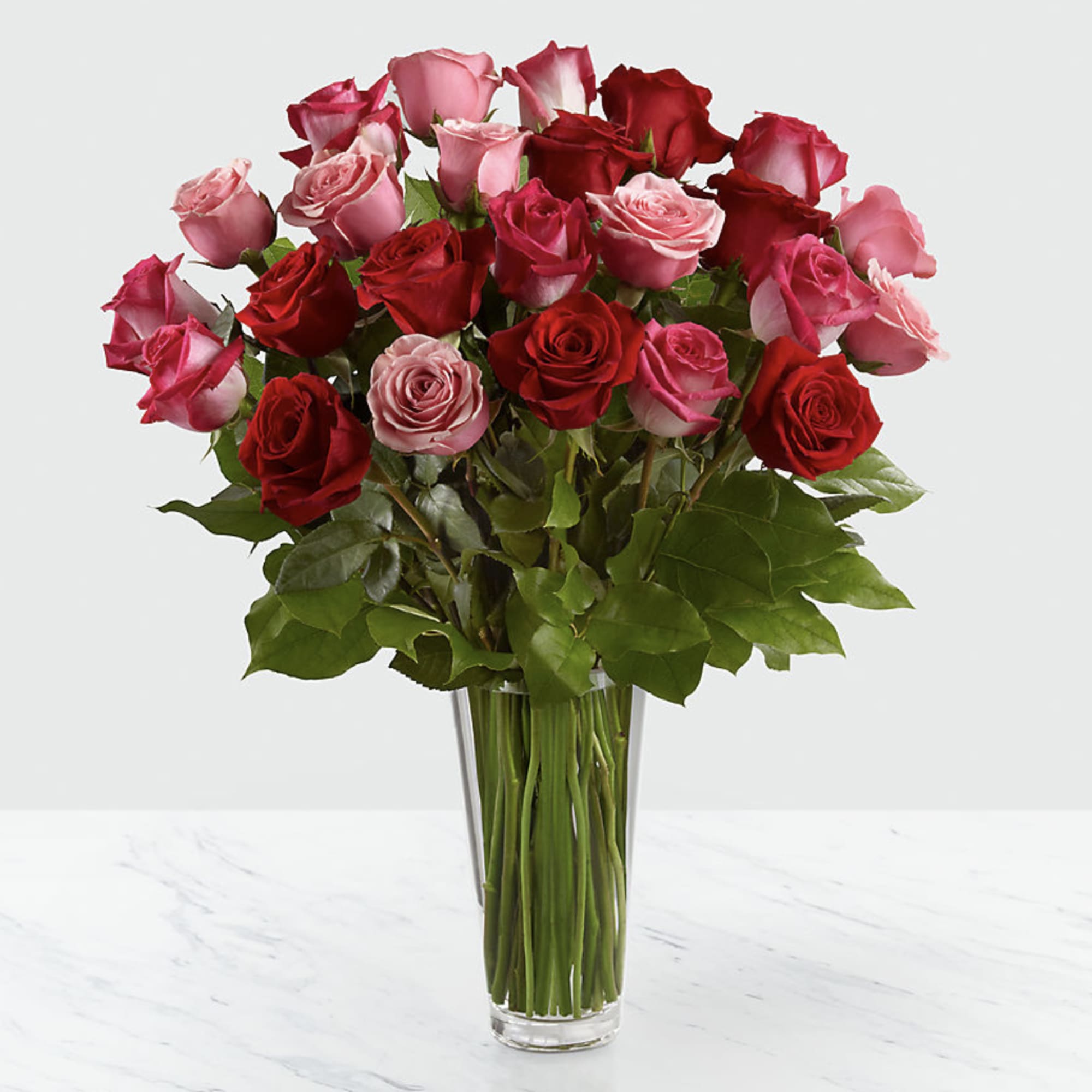 Bouquet of red and pink roses in a clear glass vase, photo 3 of 3