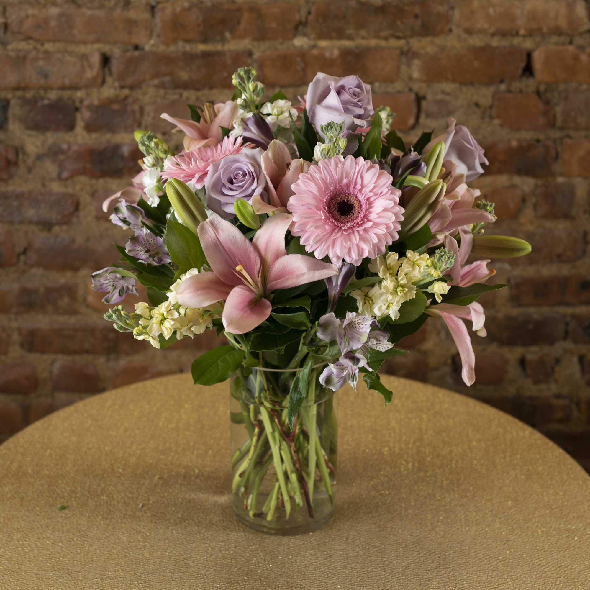 Pink and lavender mixed bouquet in a clear glass vase