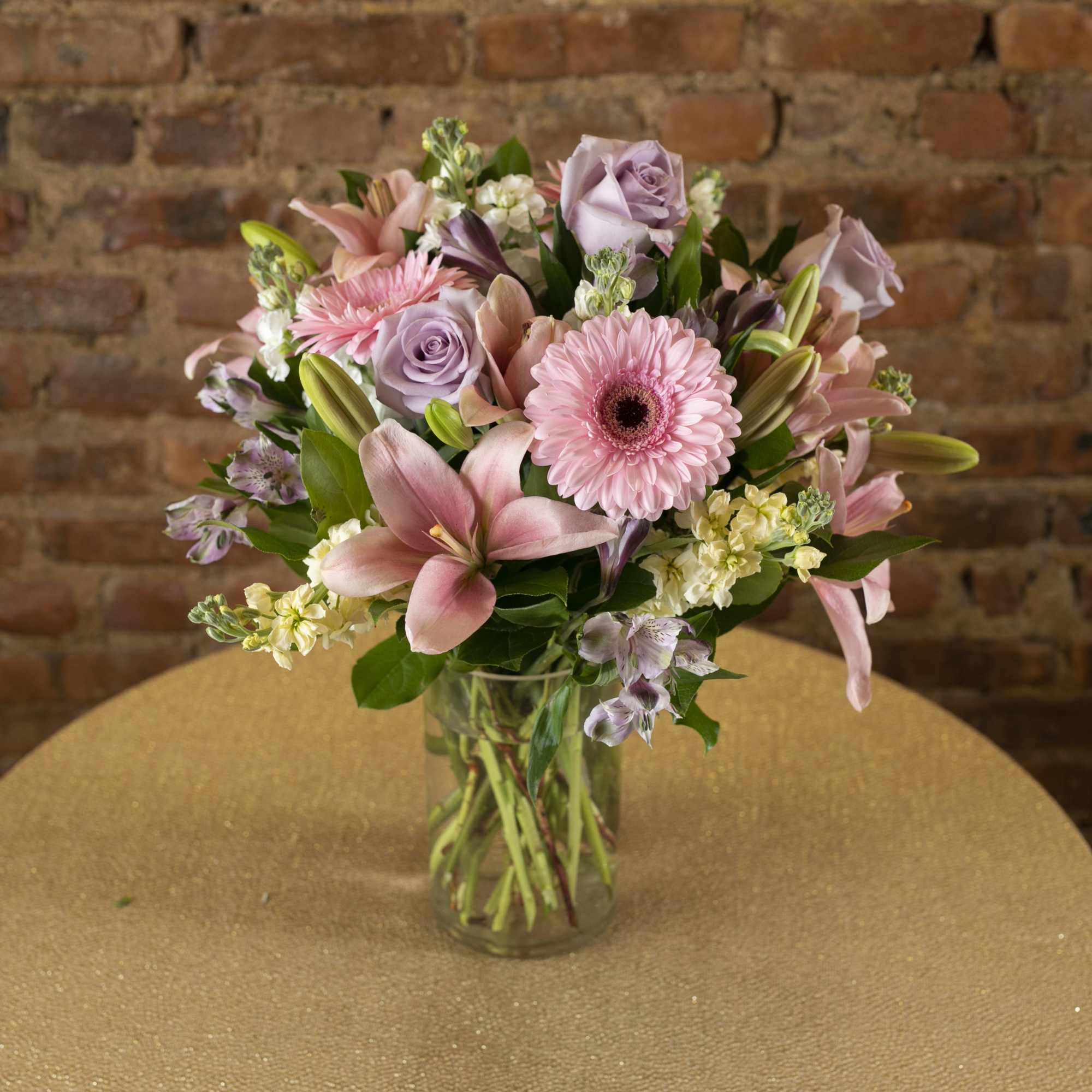 Pink and lavender mixed bouquet in a clear glass vase, photo 2 of 2