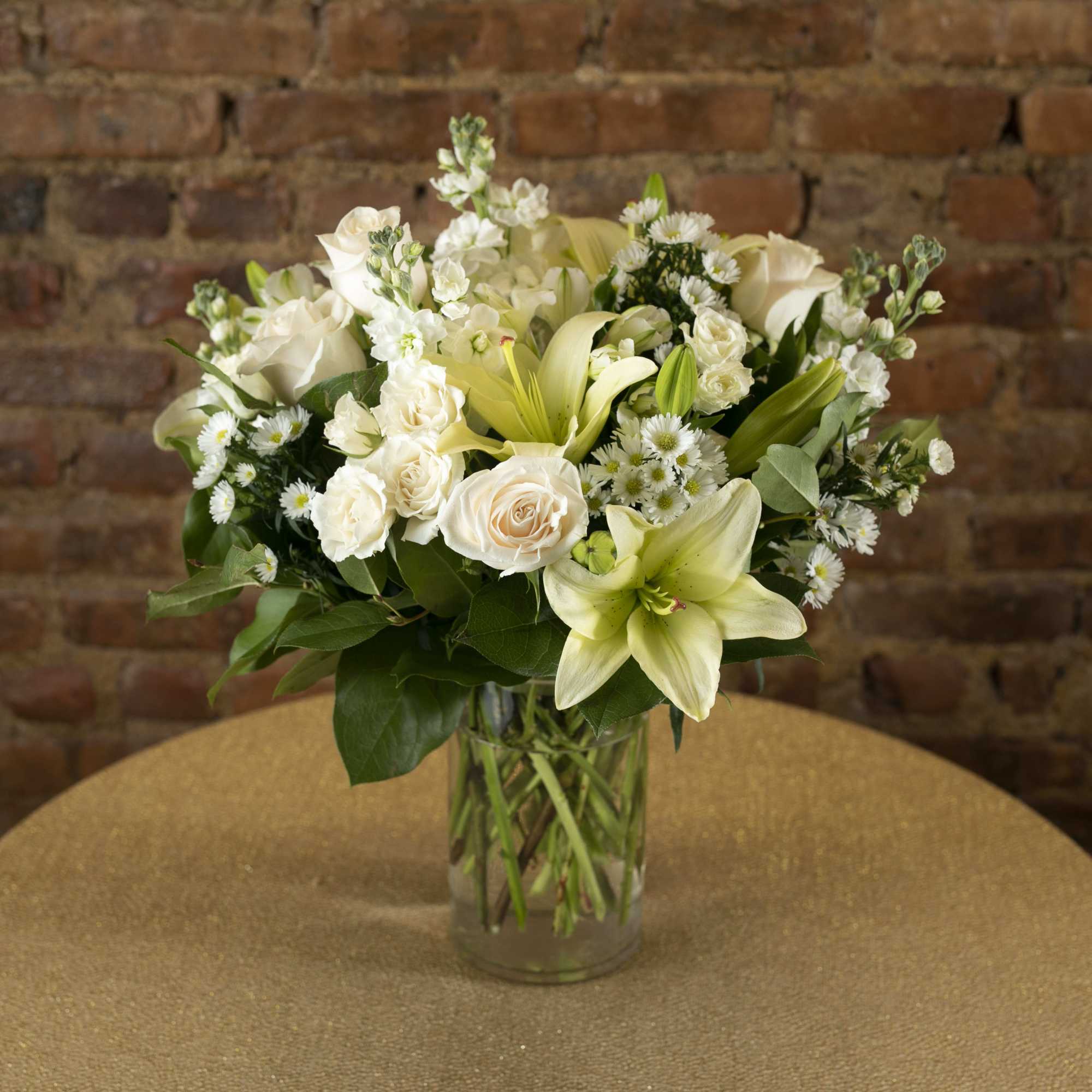 White floral arrangement in a clear glass vase