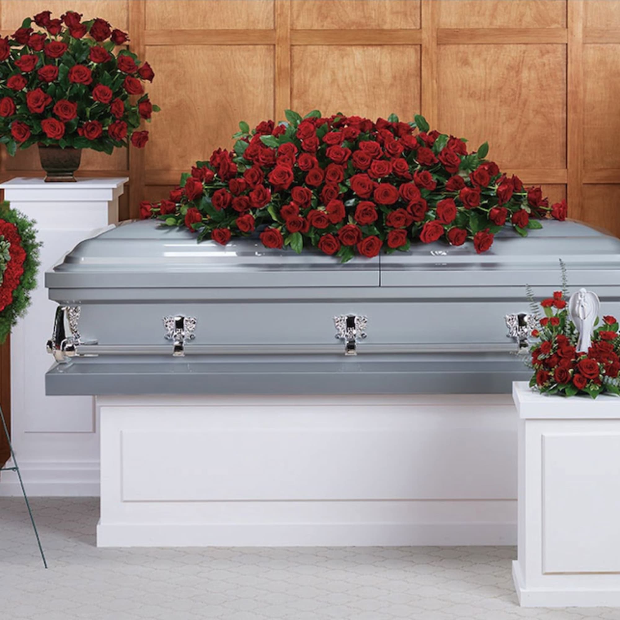 Red rose funeral casket spray with matching standing arrangements