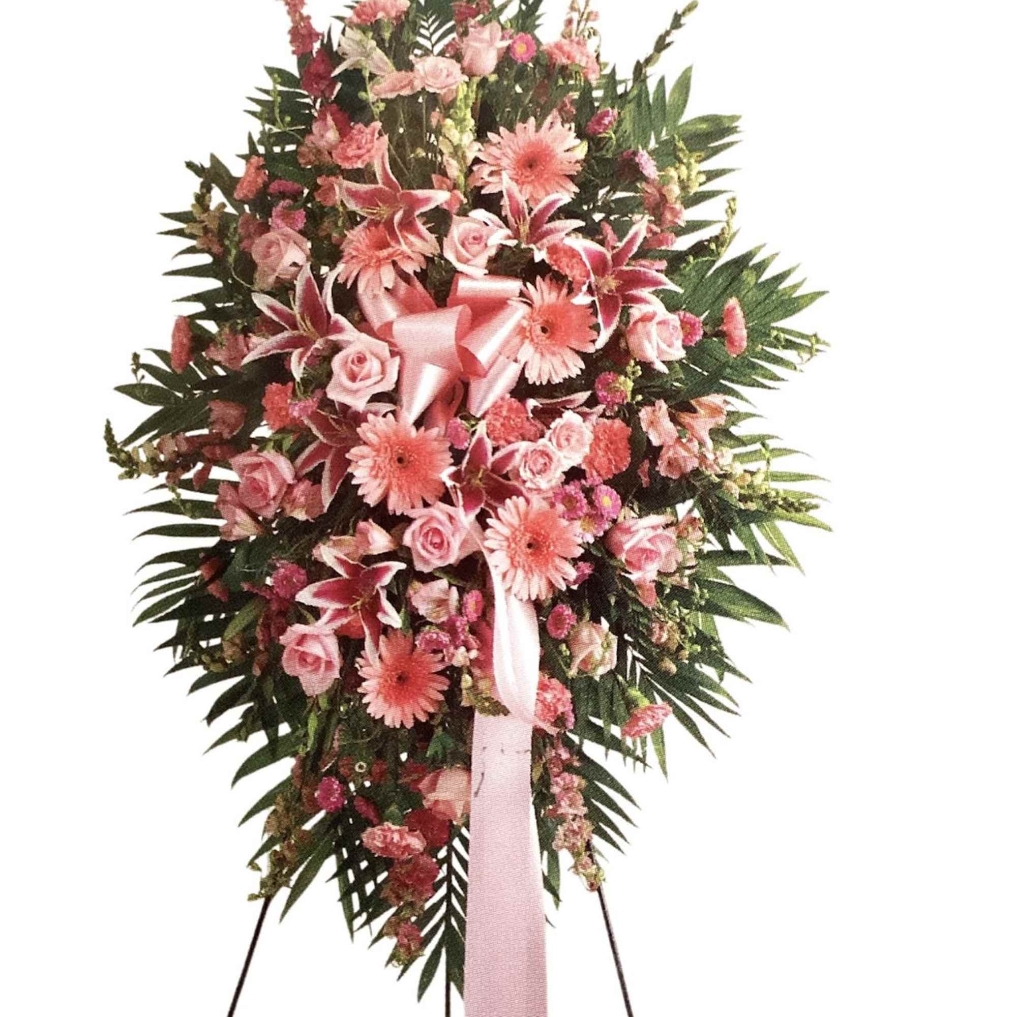Pink floral standing spray with ribbon on an easel