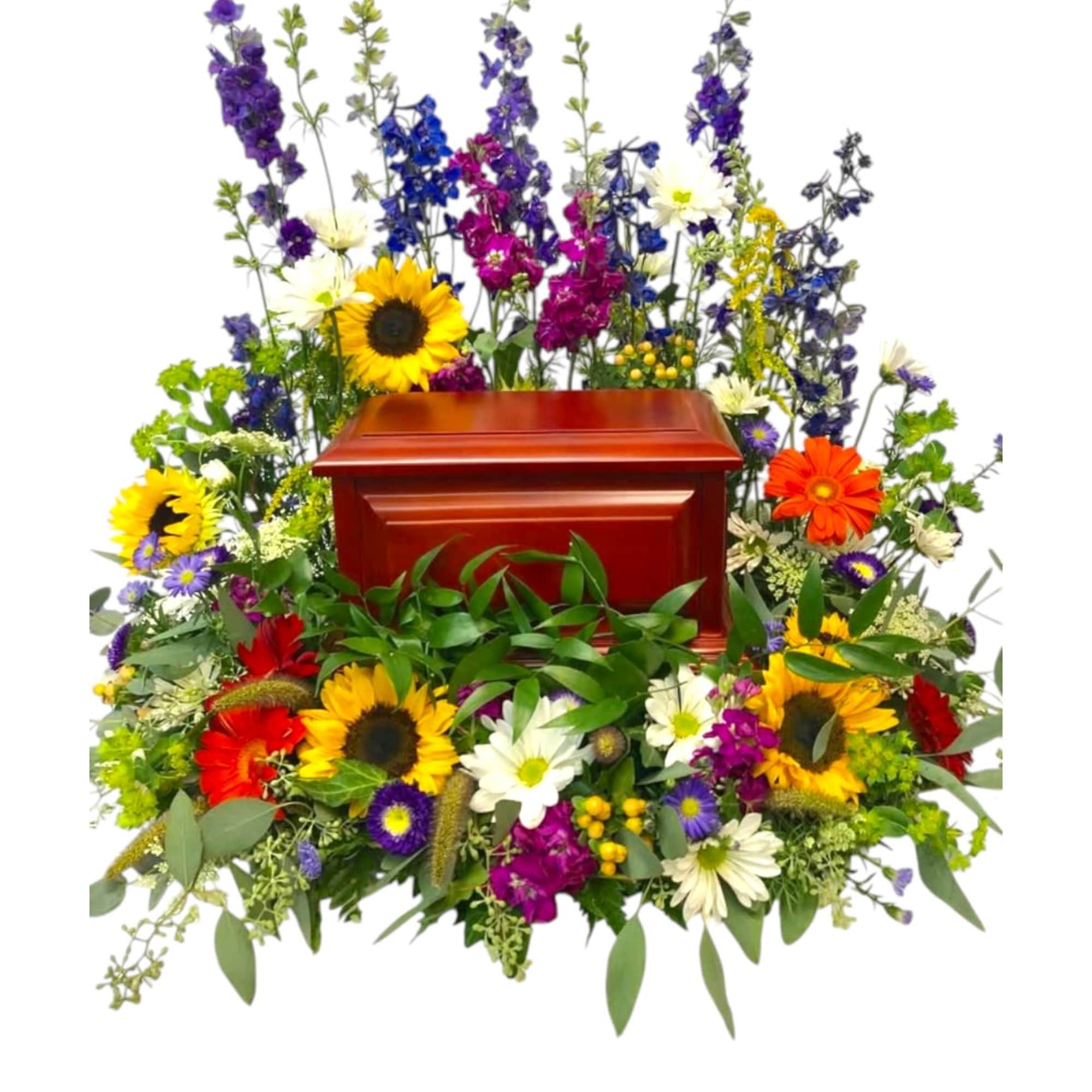 Colorful funeral casket spray with sunflowers and mixed blooms