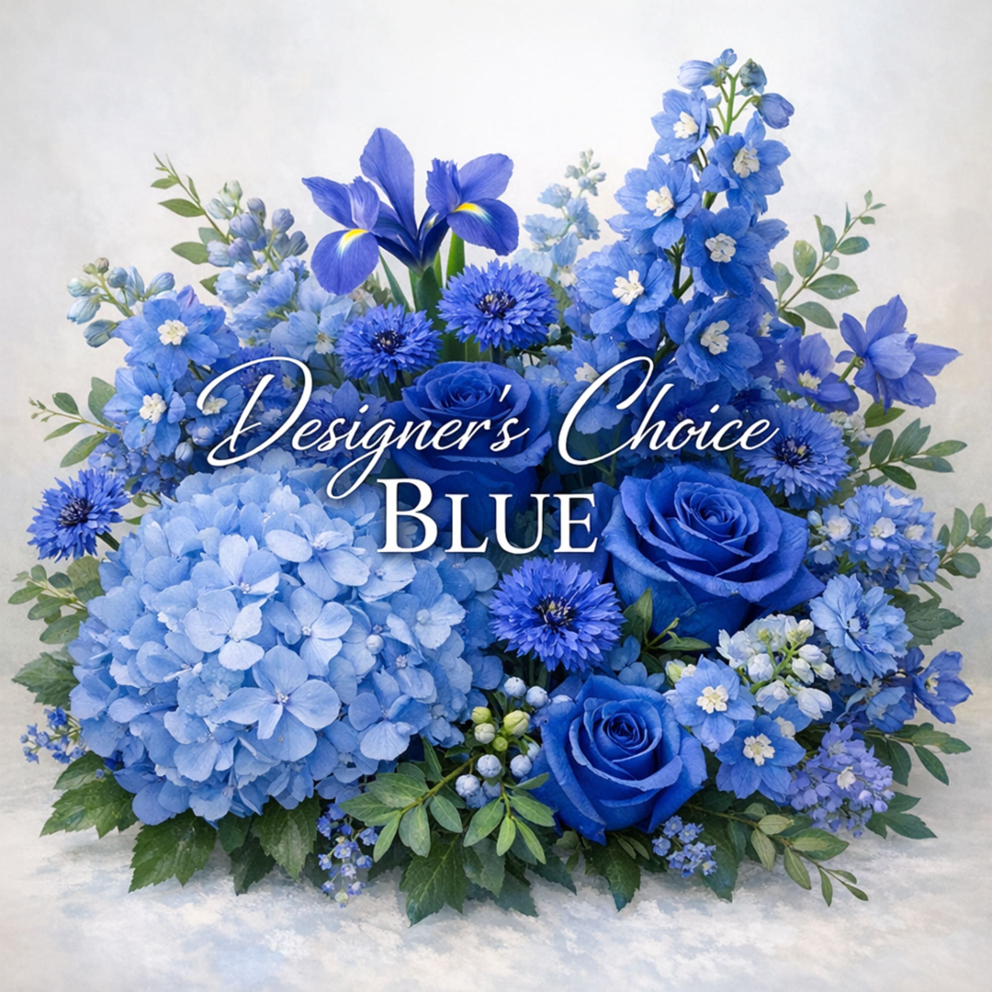 Blue floral arrangement with roses, hydrangeas, iris, and other mixed blue blooms