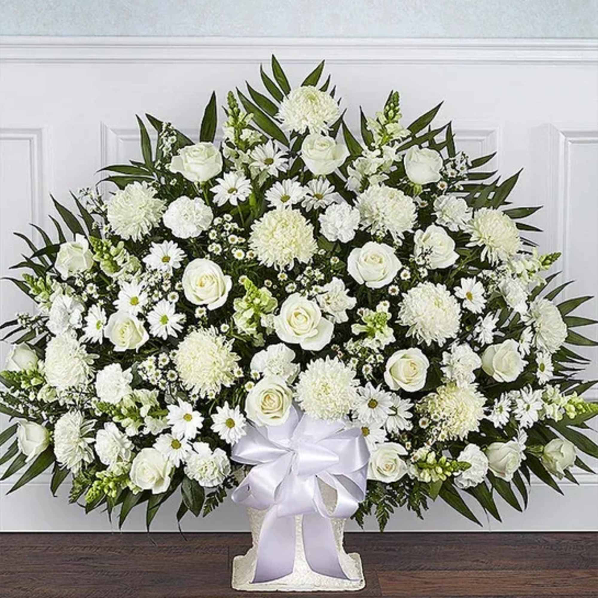 All-white floor basket arrangement of roses, football mums, snapdragons, carnations, daisy poms