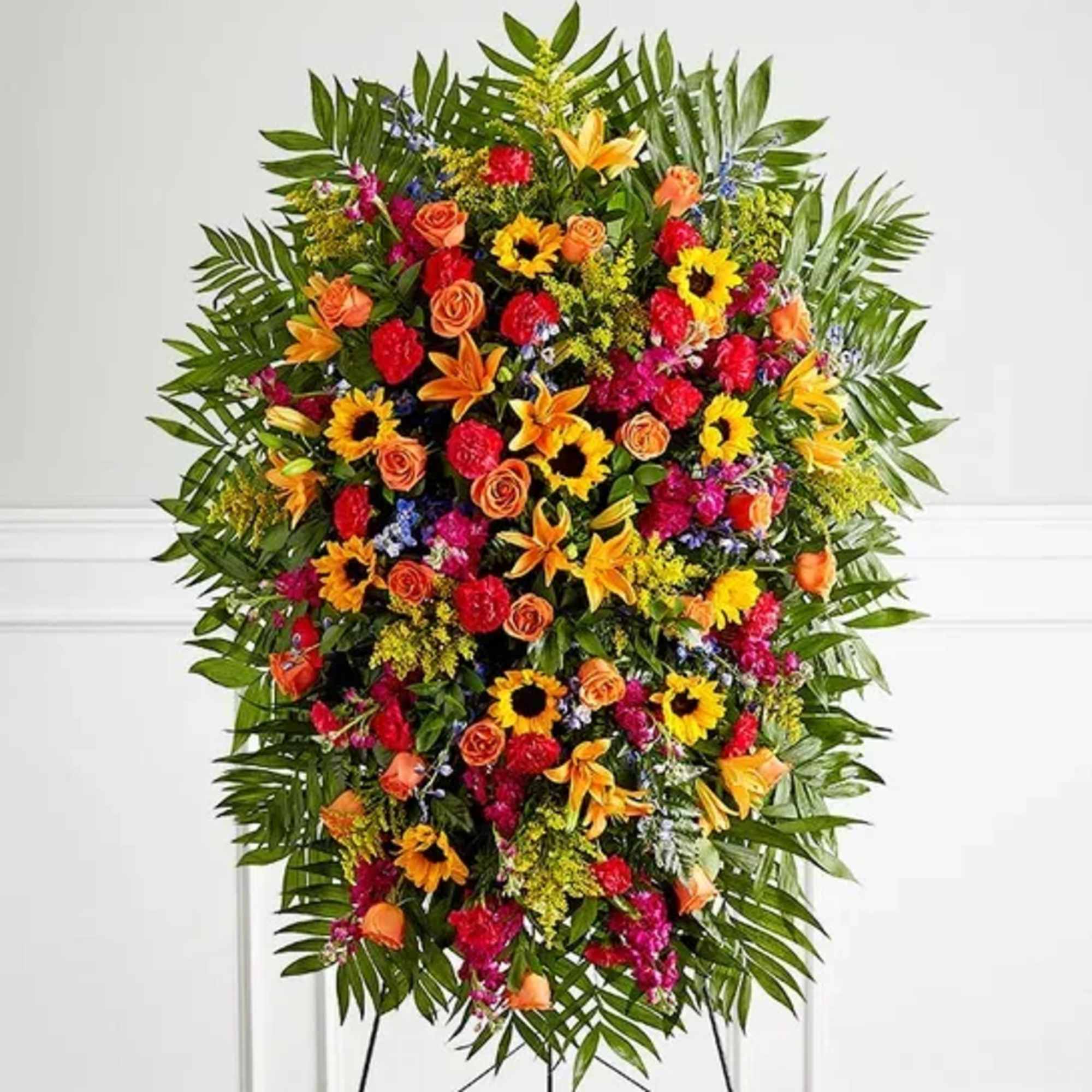 One-sided standing spray arrangement with orange roses and Asiatic lilies, golden sunflowers