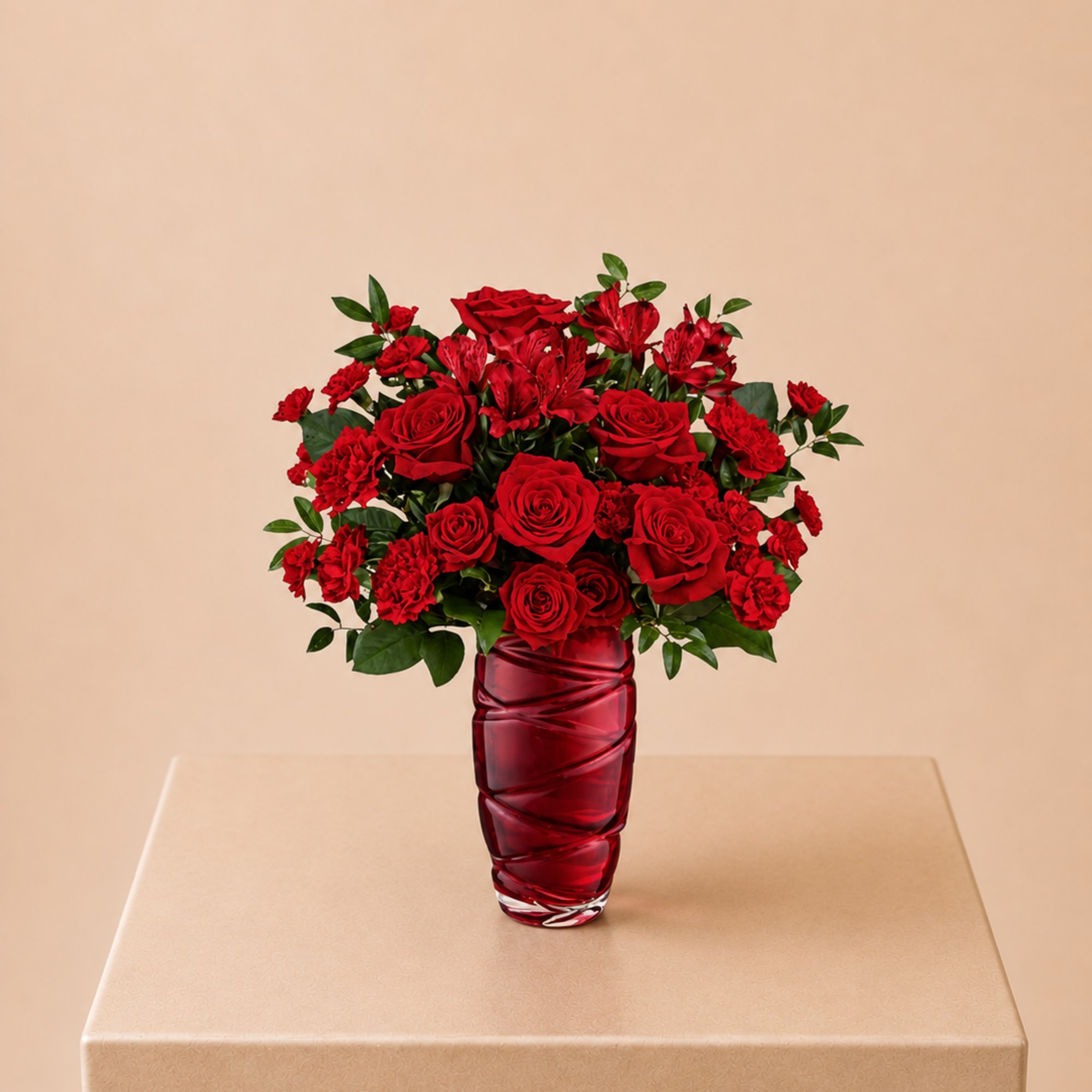 A bold and passionate arrangement of red roses, carnations, and alstroemeria in