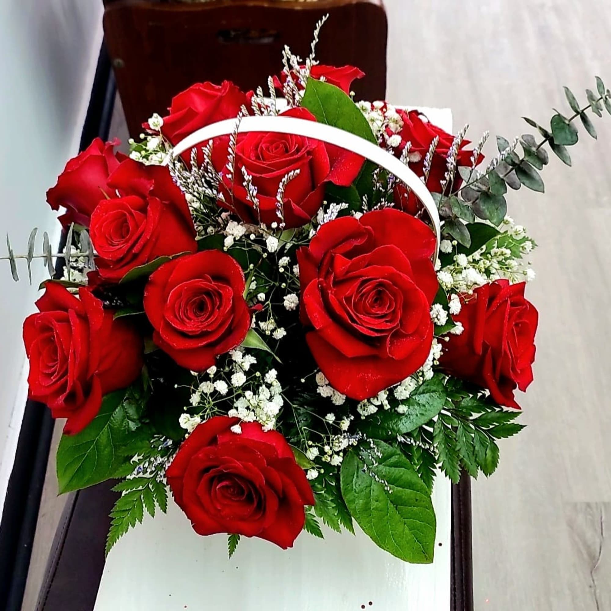Bouquet of red roses with white baby's breath and greenery
