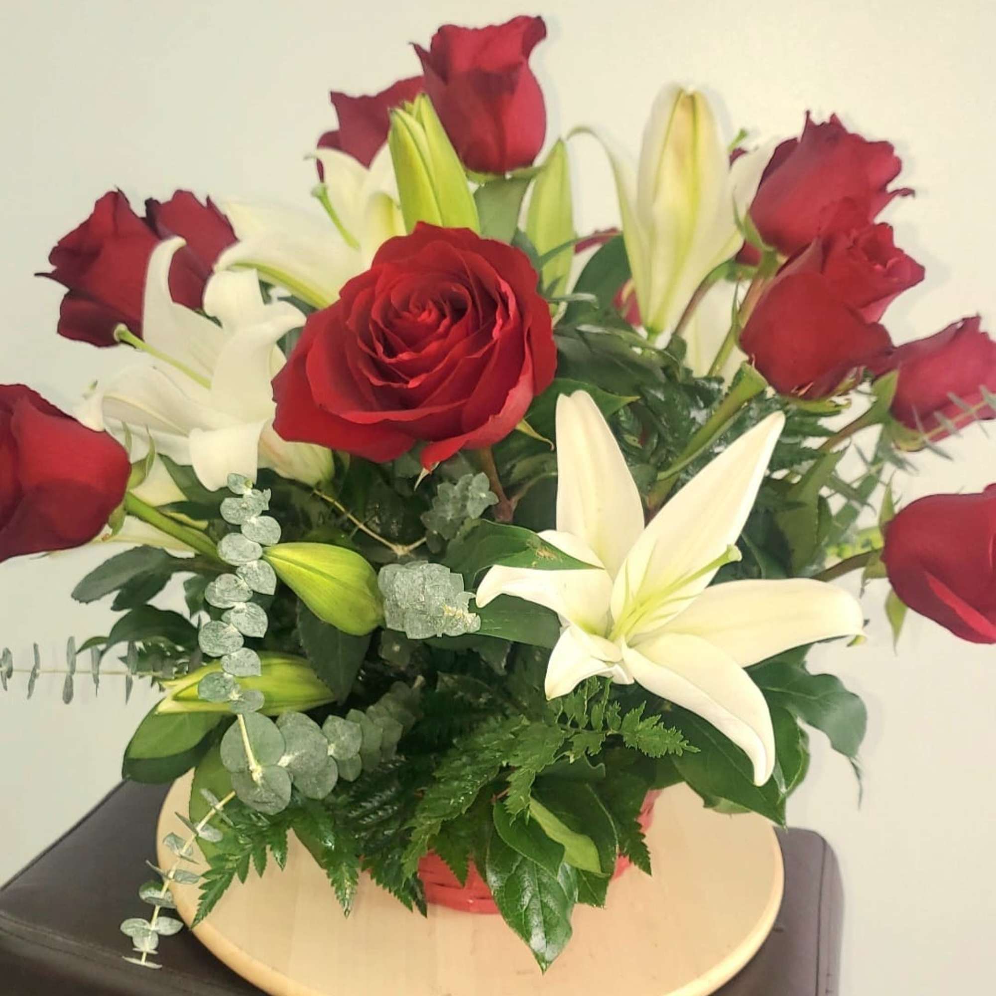 Bouquet of red roses and white lilies in a vase