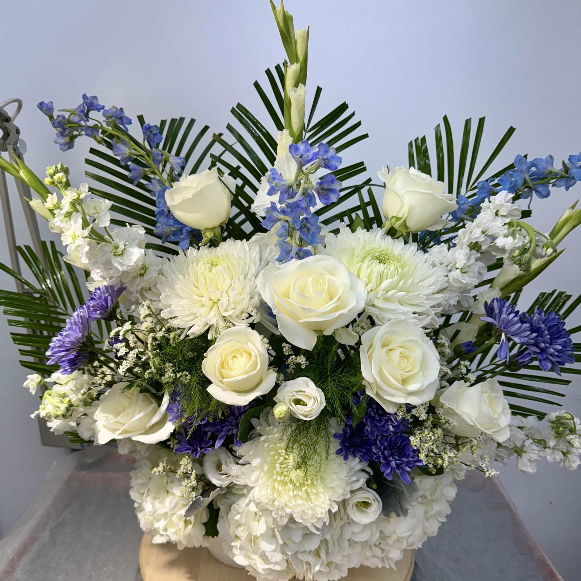 White roses and chrysanthemums with blue flowers in a low arrangement, photo 2 of 2