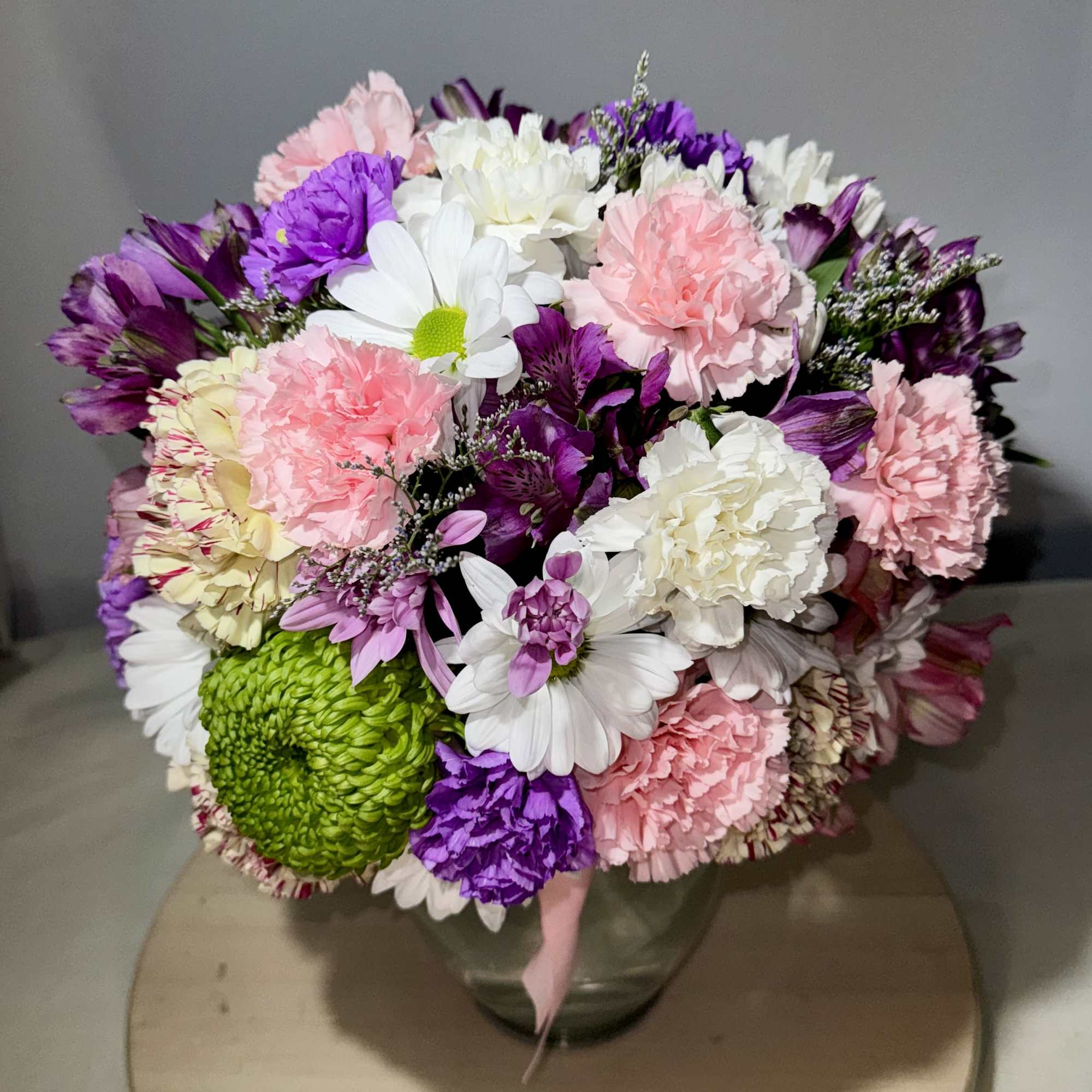 Mixed bouquet of pink, purple, white, and green flowers in a glass vase, photo 2 of 3