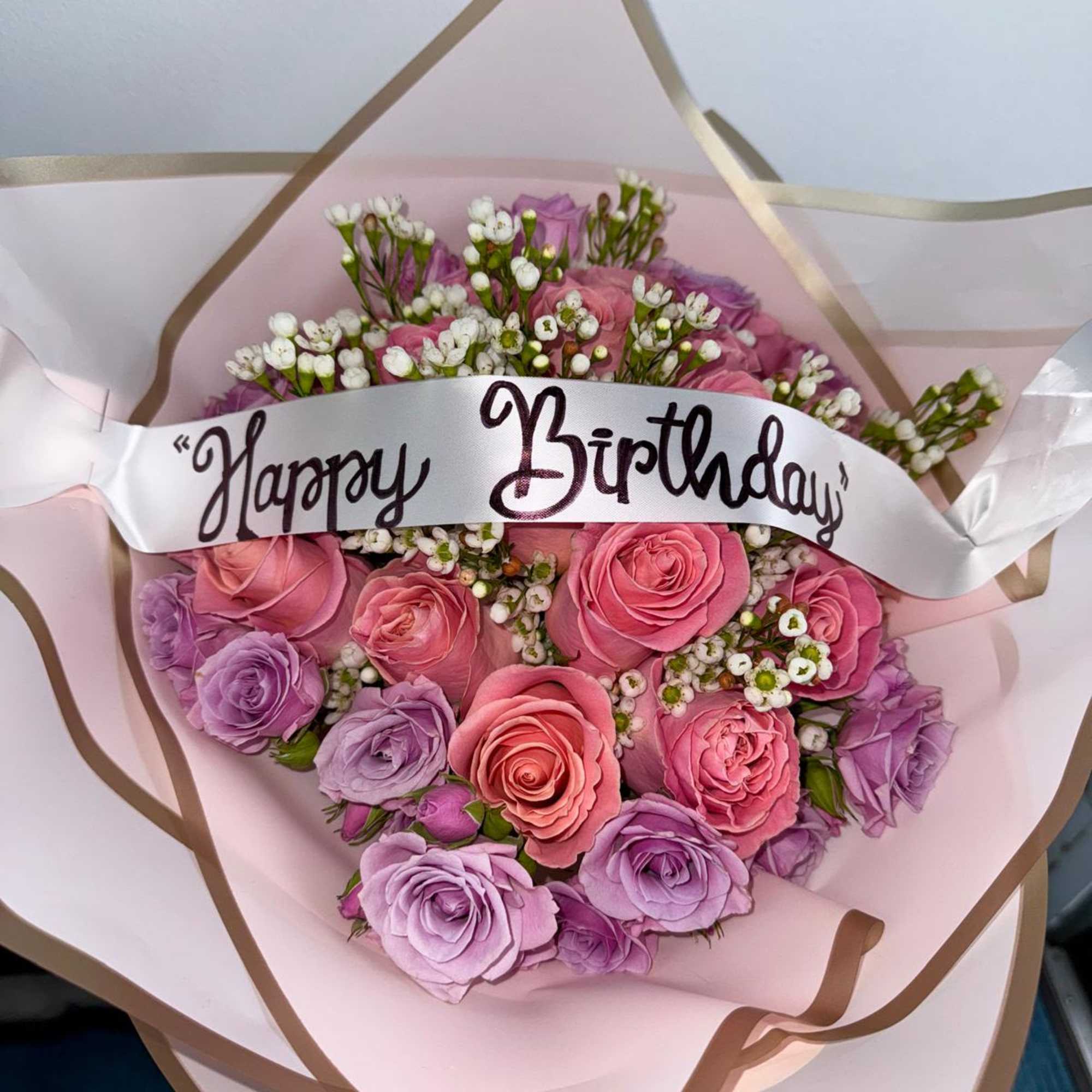 Pink and lavender rose bouquet with a Happy Birthday ribbon
