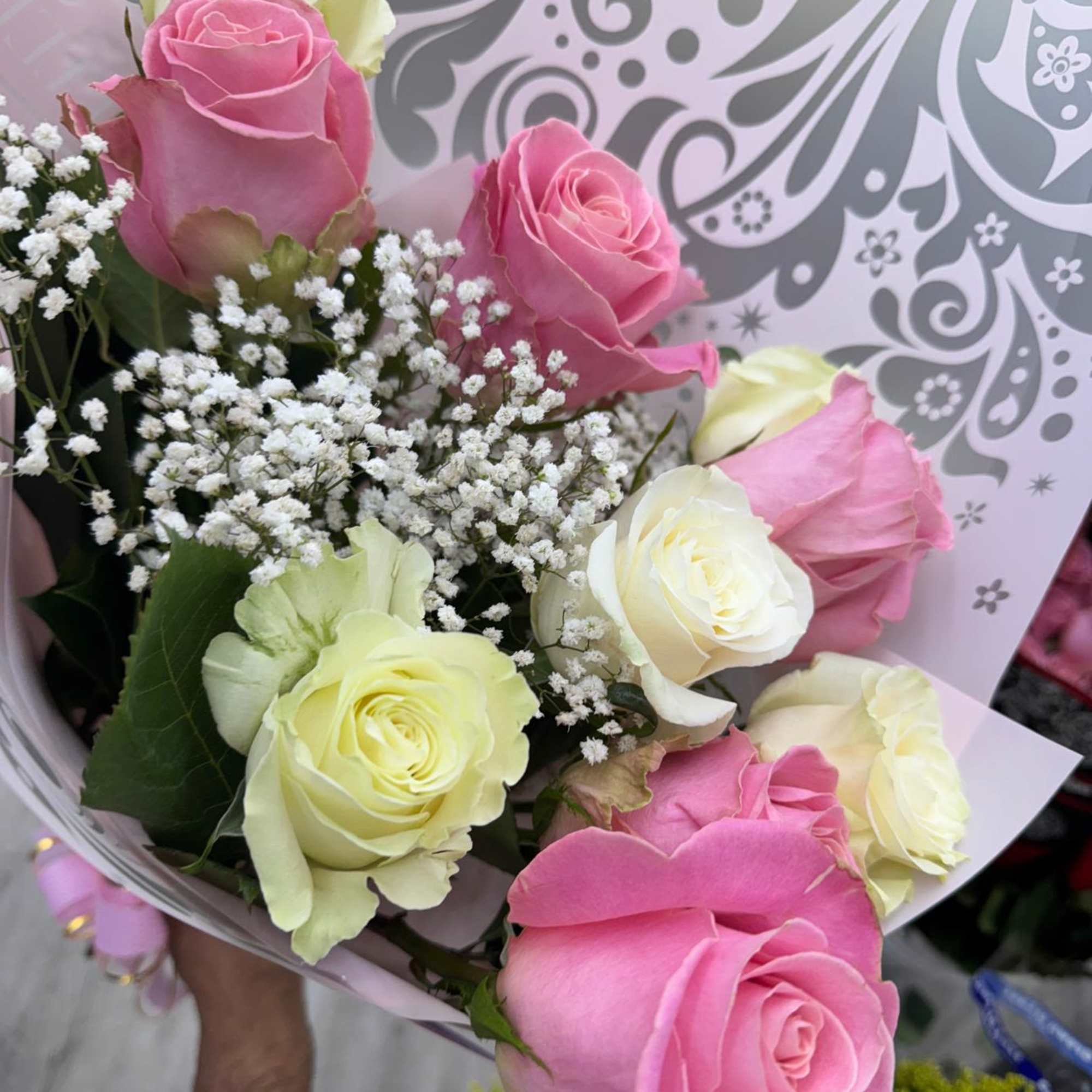 Bouquet of pink and pale yellow roses with baby's breath