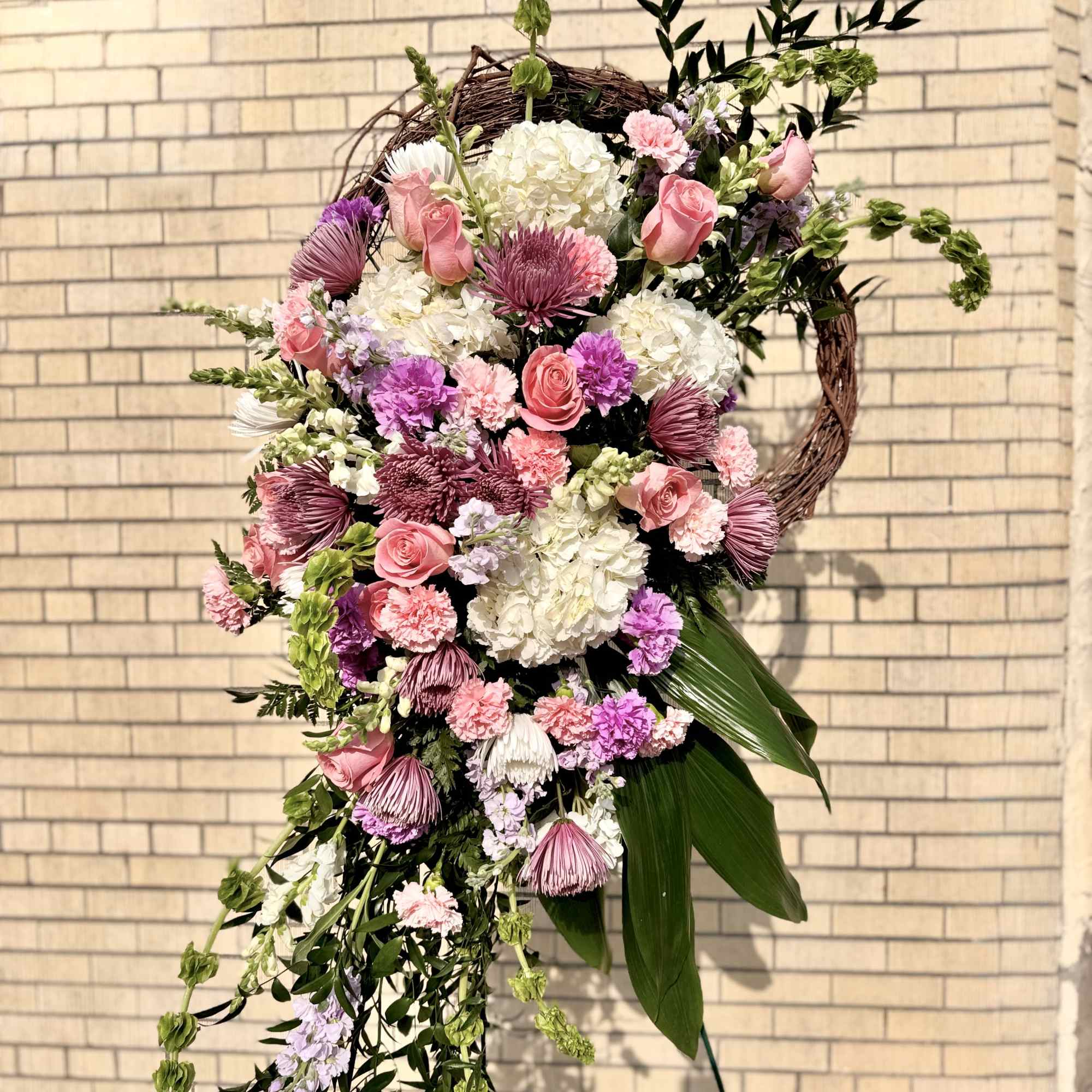 Large cascading floral wreath with pink and white blooms