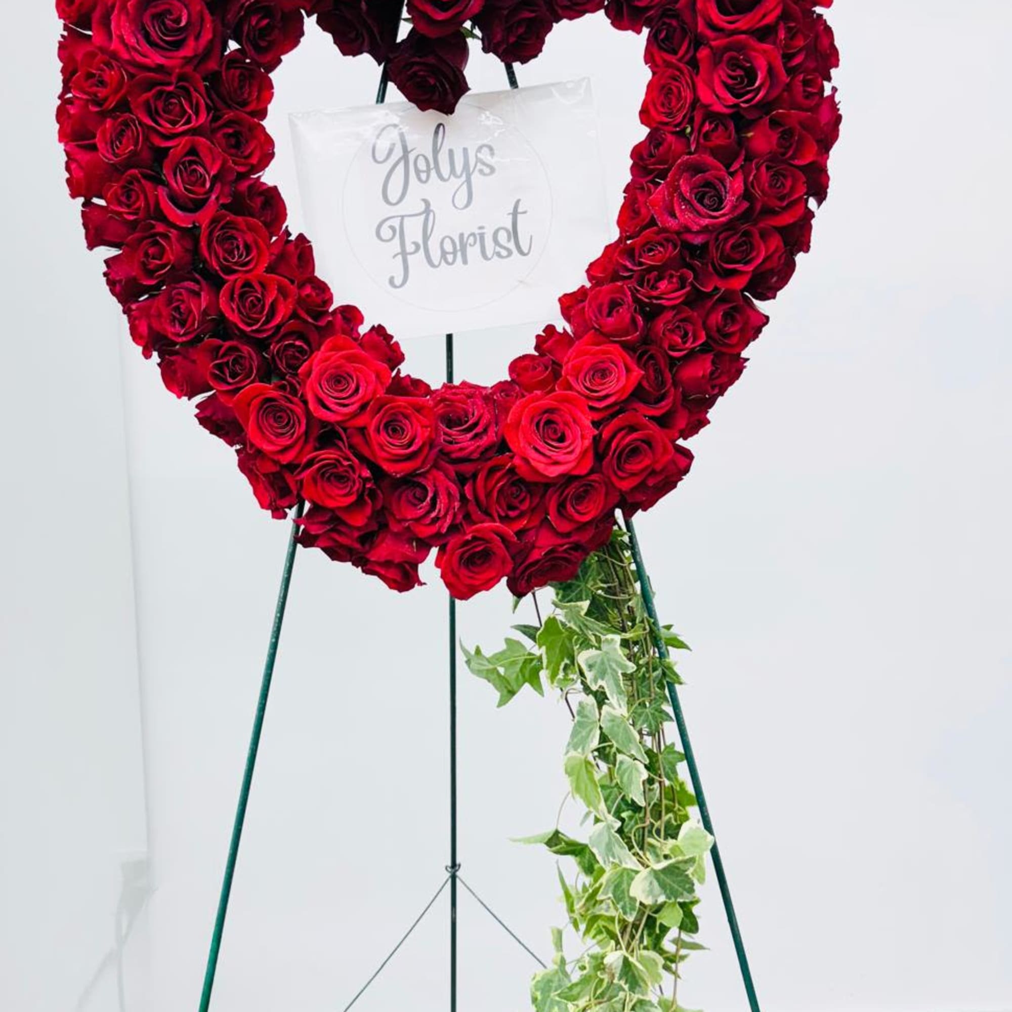 Heart-shaped red rose standing arrangement with trailing ivy