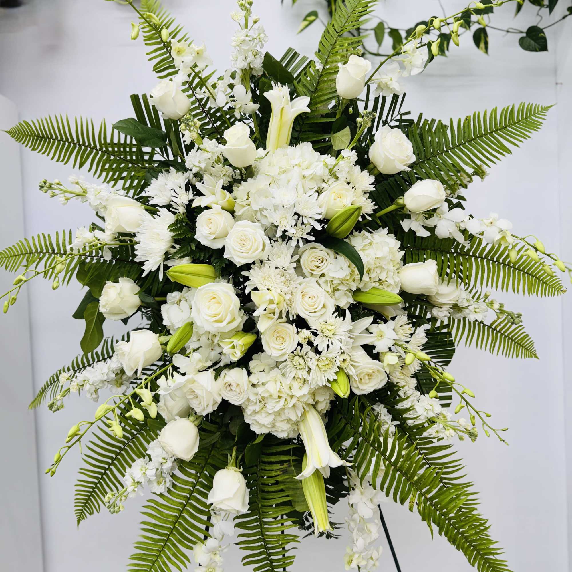 An all white tribute, this funeral spray is pure and tranquil. Featuring