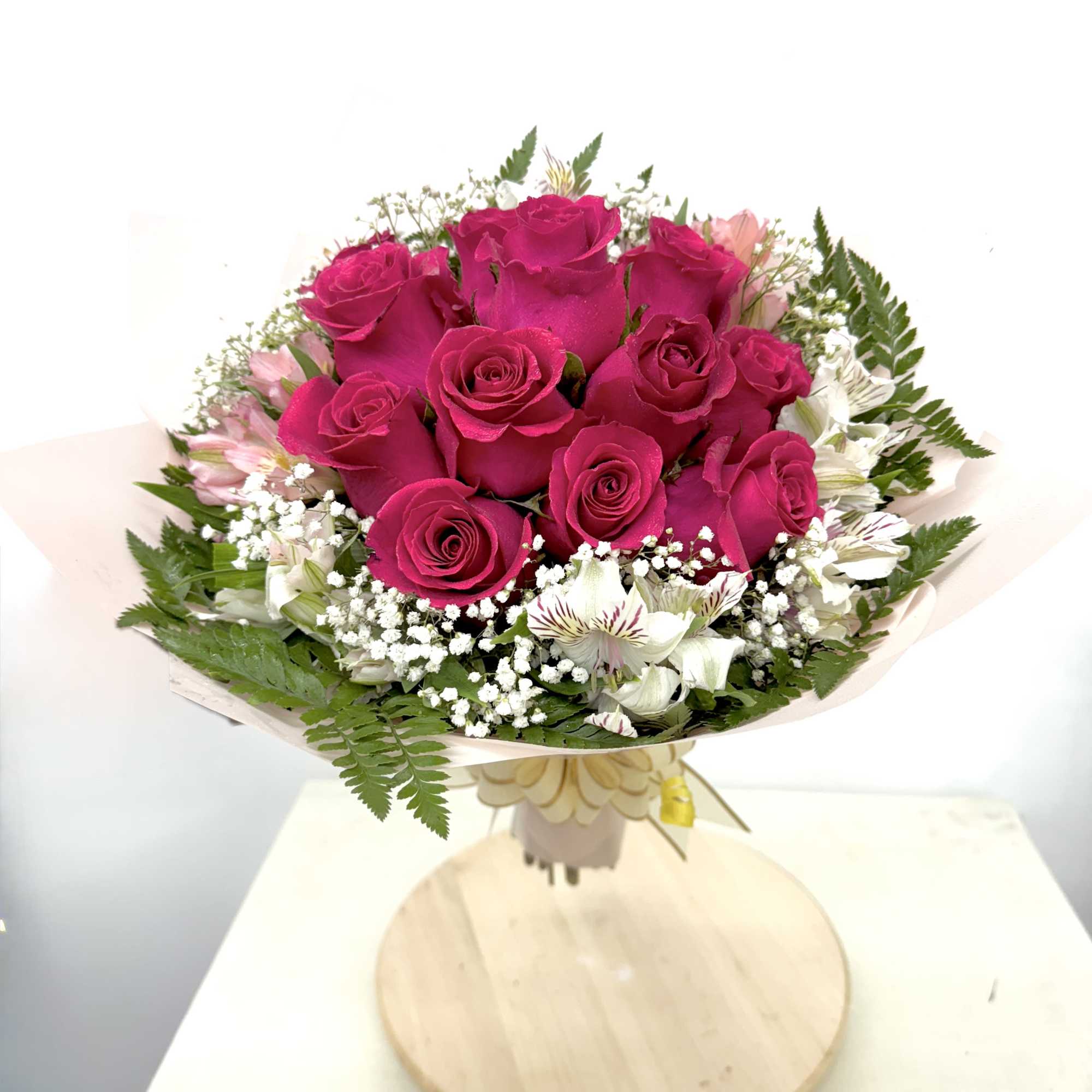 Bouquet of hot pink roses with white accent flowers