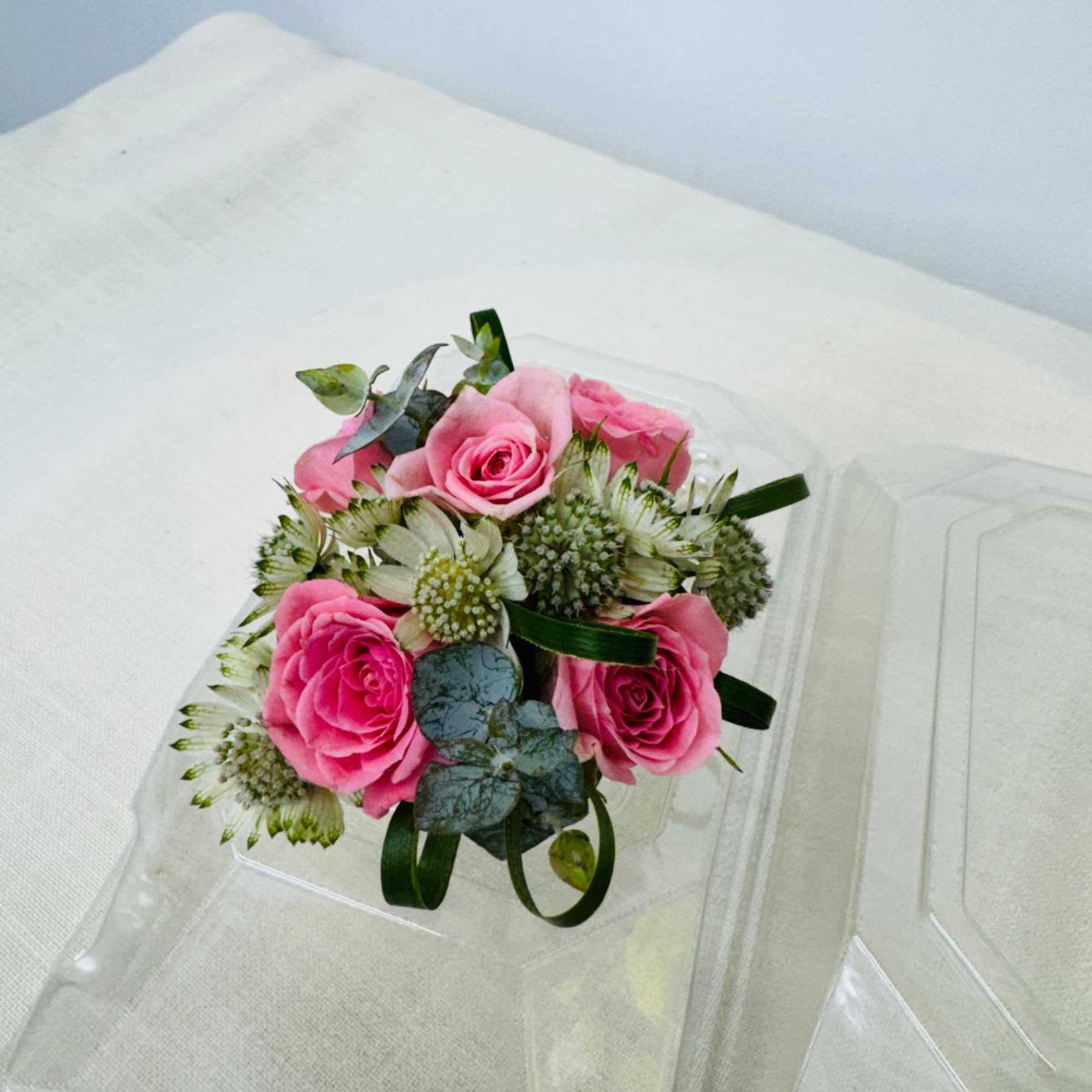 A classic  pink rose and baby's breath corsage compliments any outfit., photo 3 of 3