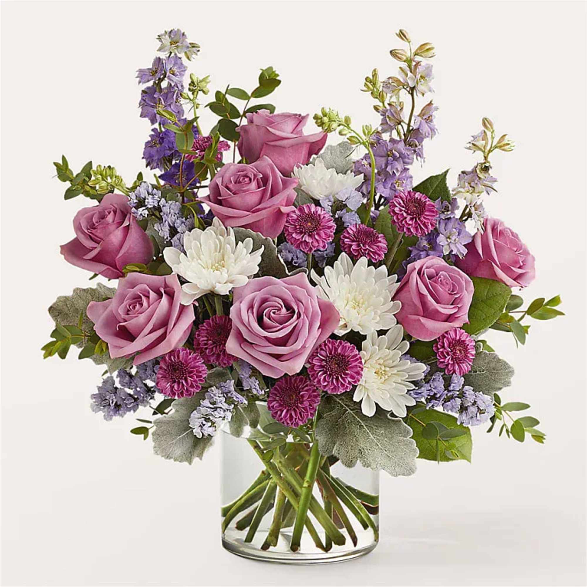 Pink roses and white daisies in a clear glass vase