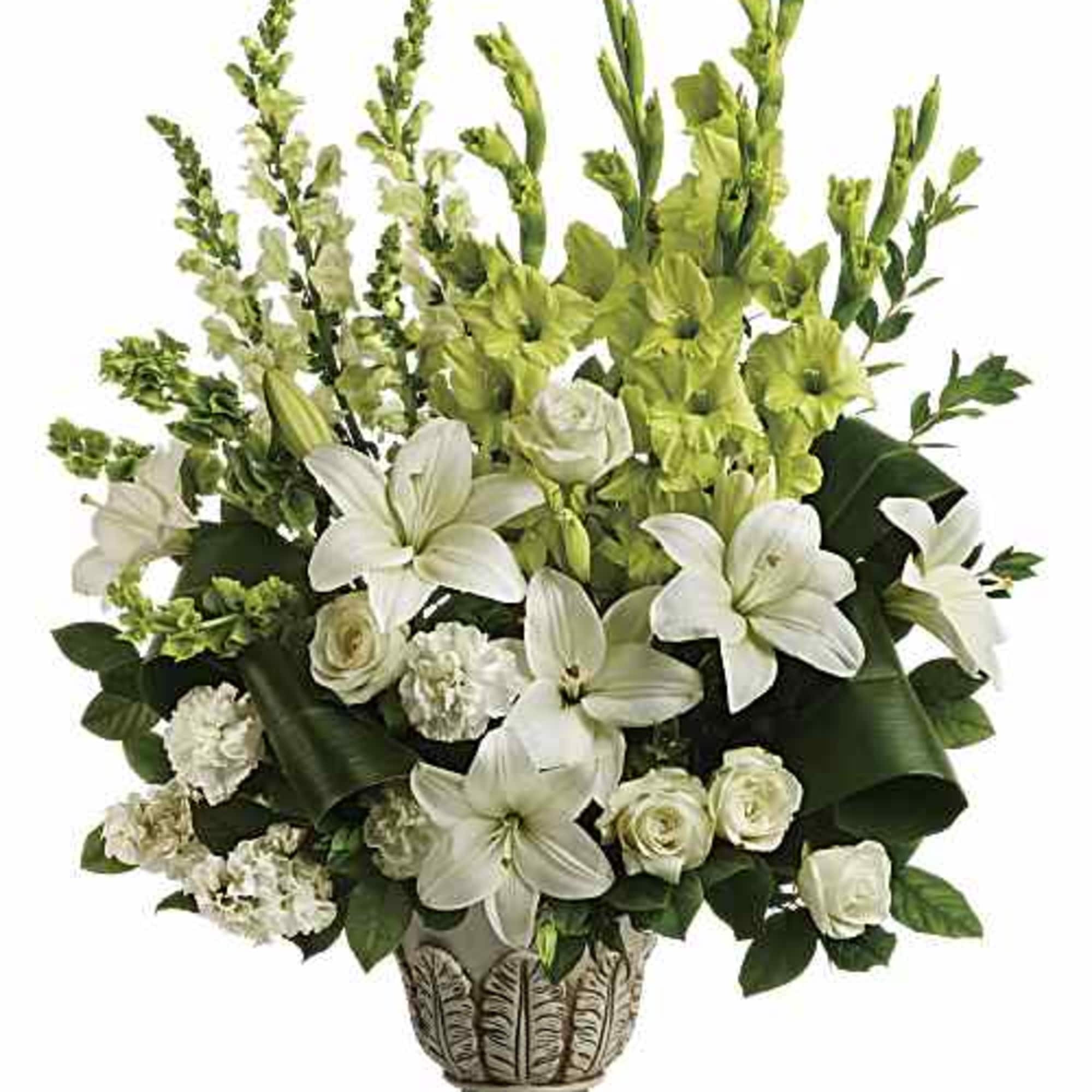 White lilies and roses in a decorative pedestal vase with green accents