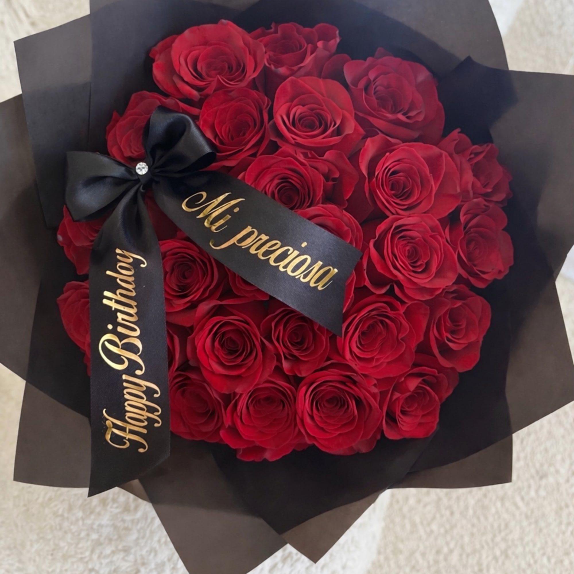 A timeless bouquet of 24 premium red roses, beautifully wrapped and finished