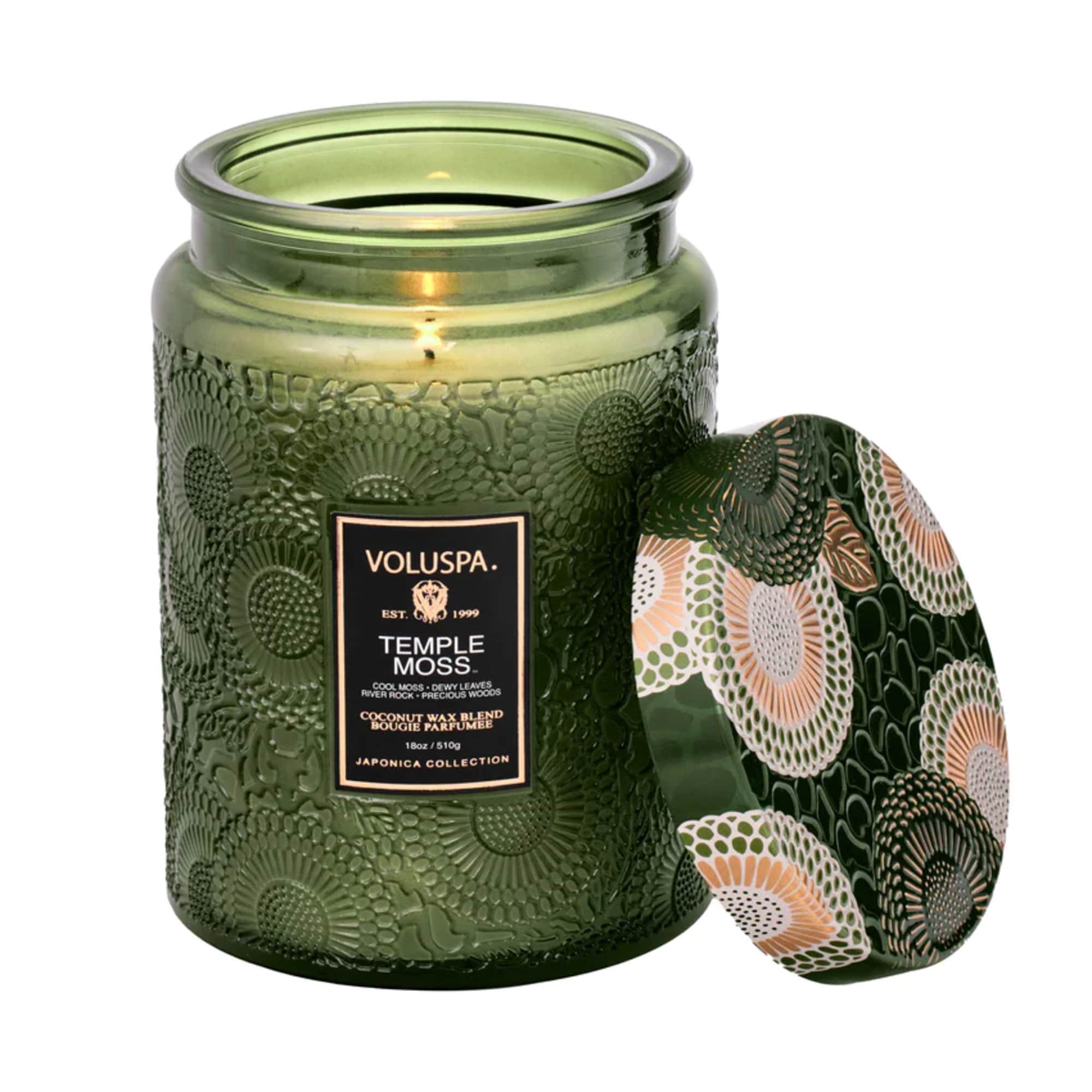 Green glass candle jar with a patterned lid