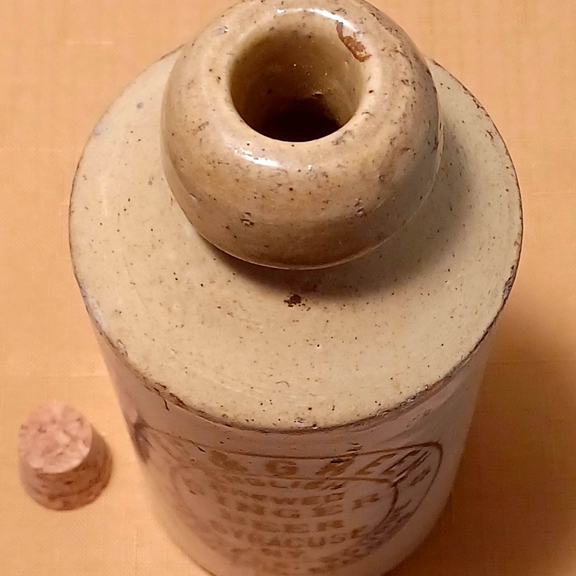 Ceramic jar with a small matching lid on a wooden surface