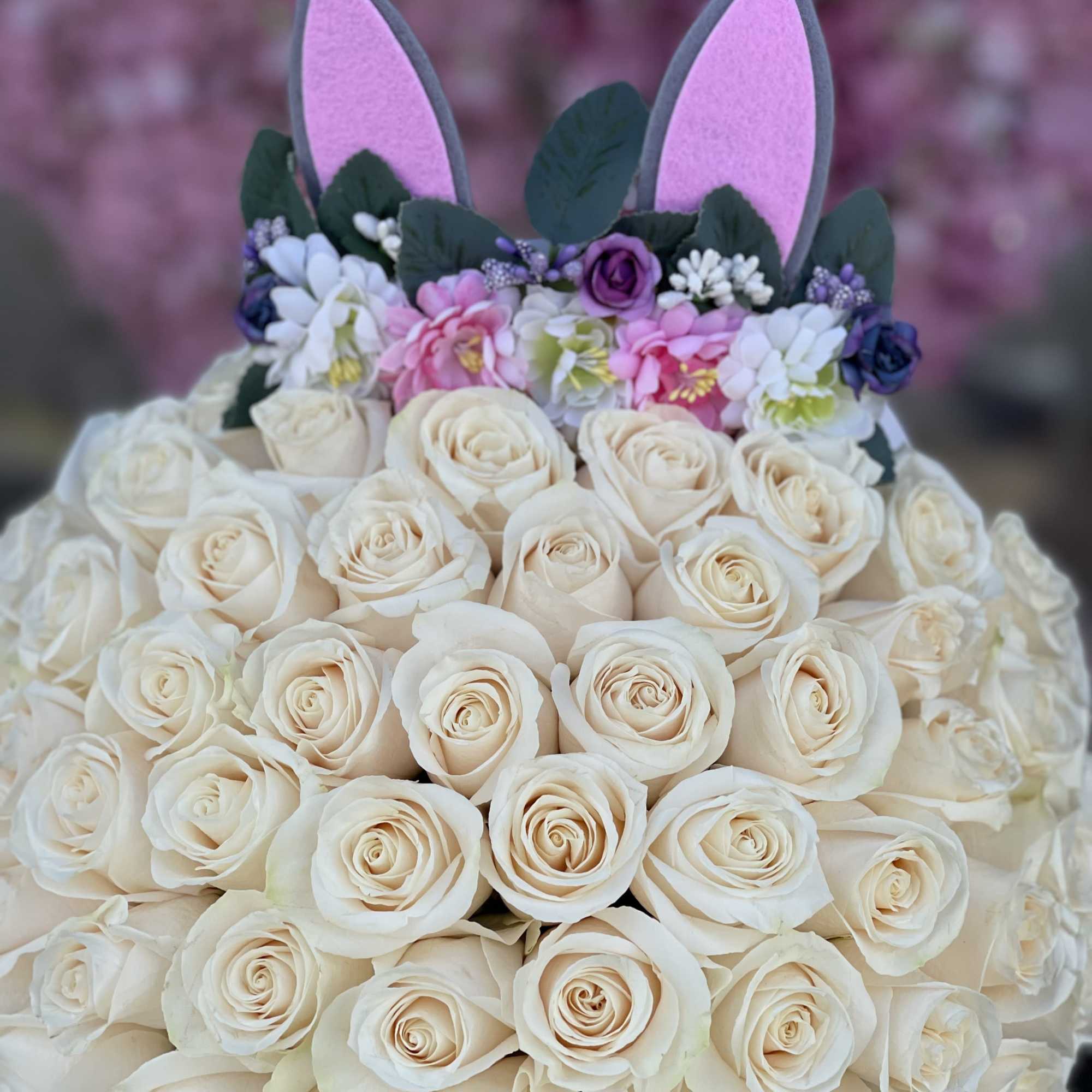 Bouquet of cream roses with pink and purple bunny ears