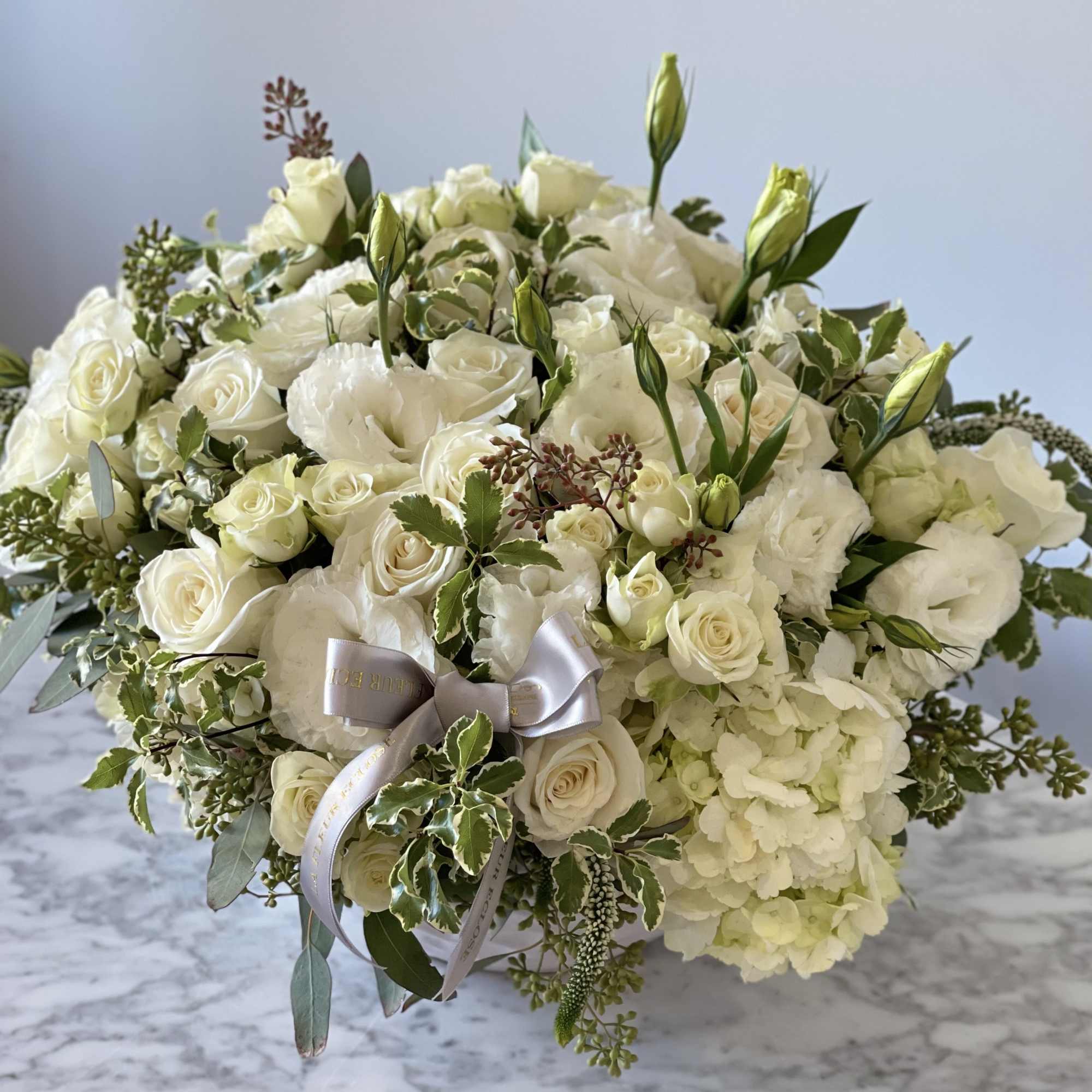 White rose and lisianthus bouquet with hydrangea and ribbon
