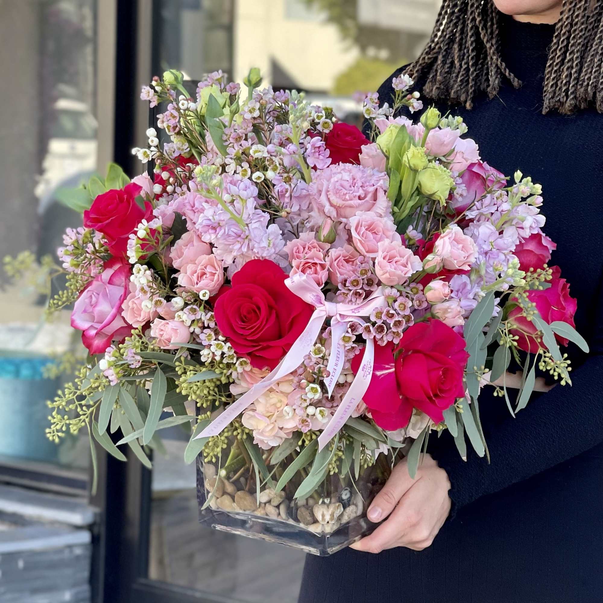 Pink and red rose bouquet in a clear glass vase