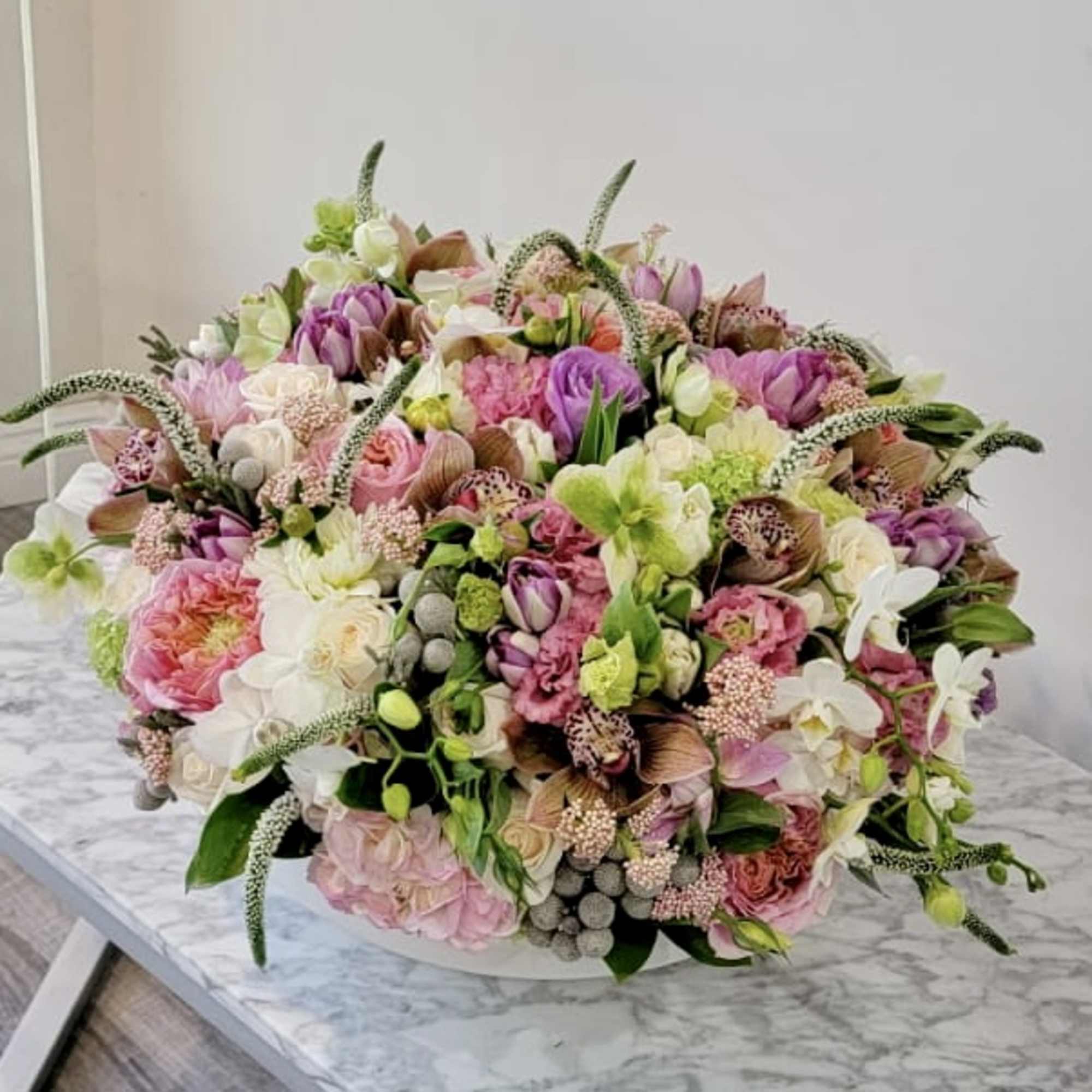 Large pastel bouquet of mixed pink, white, and green flowers