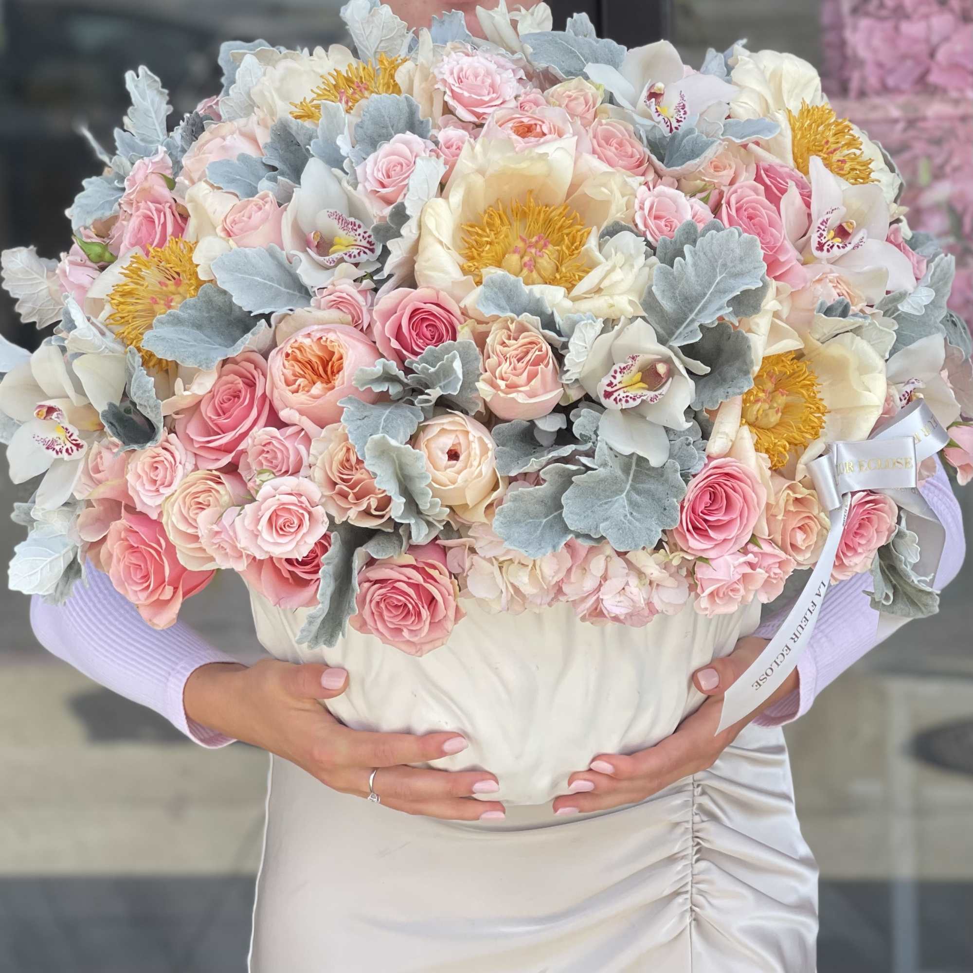 Large pastel bouquet in a white hatbox with pink and cream flowers