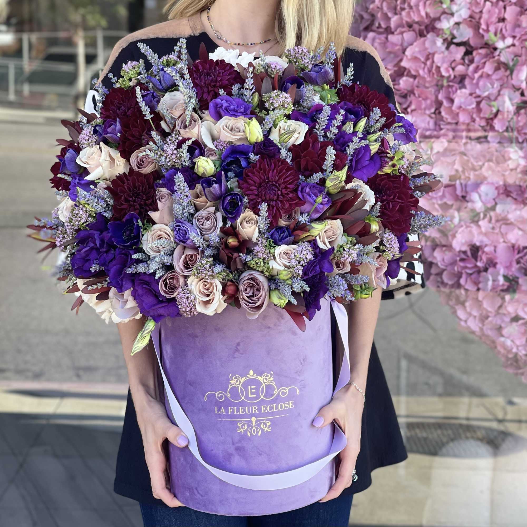 Large bouquet of purple, burgundy, and blush flowers in a lavender box