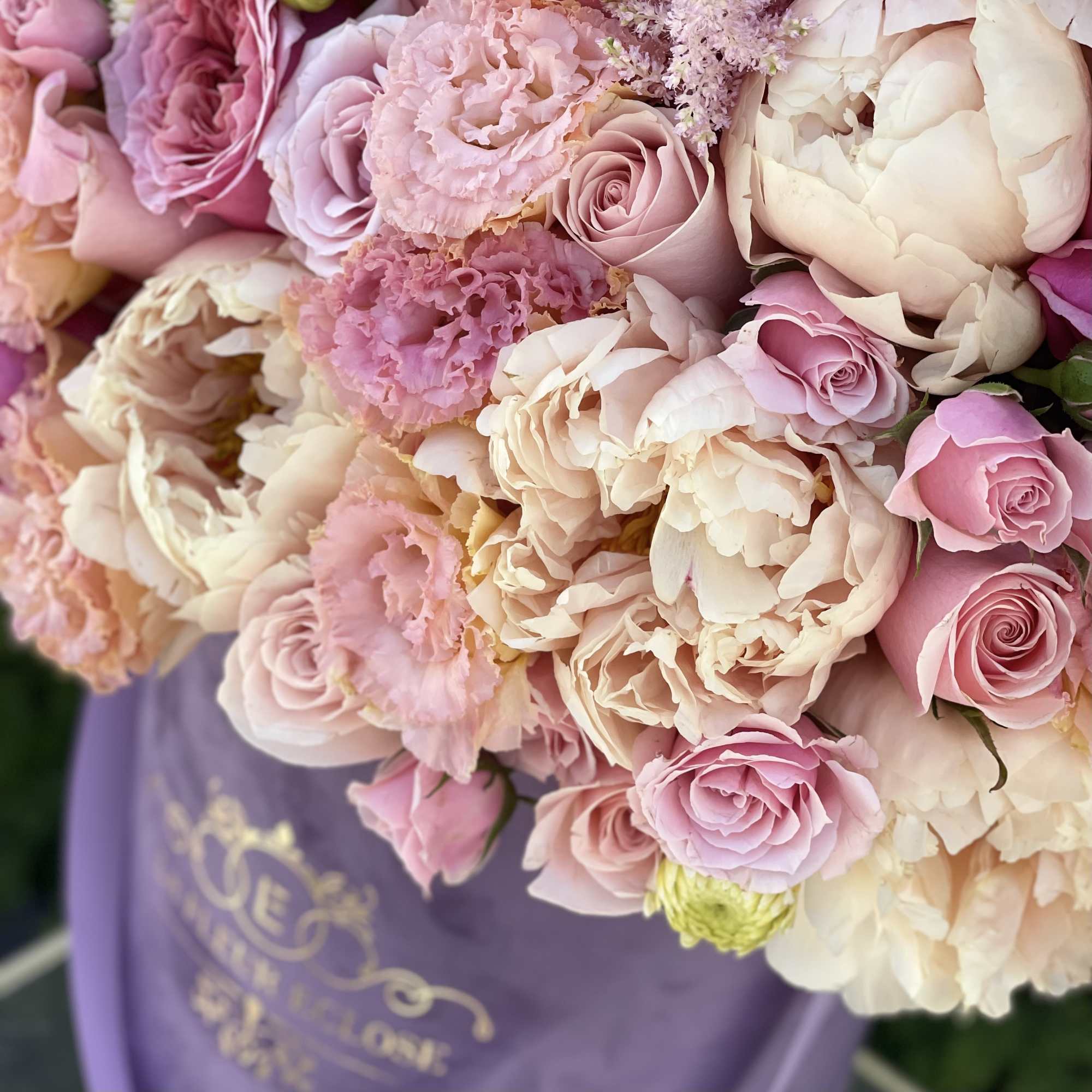 Bouquet of pink and cream roses with ruffled blooms